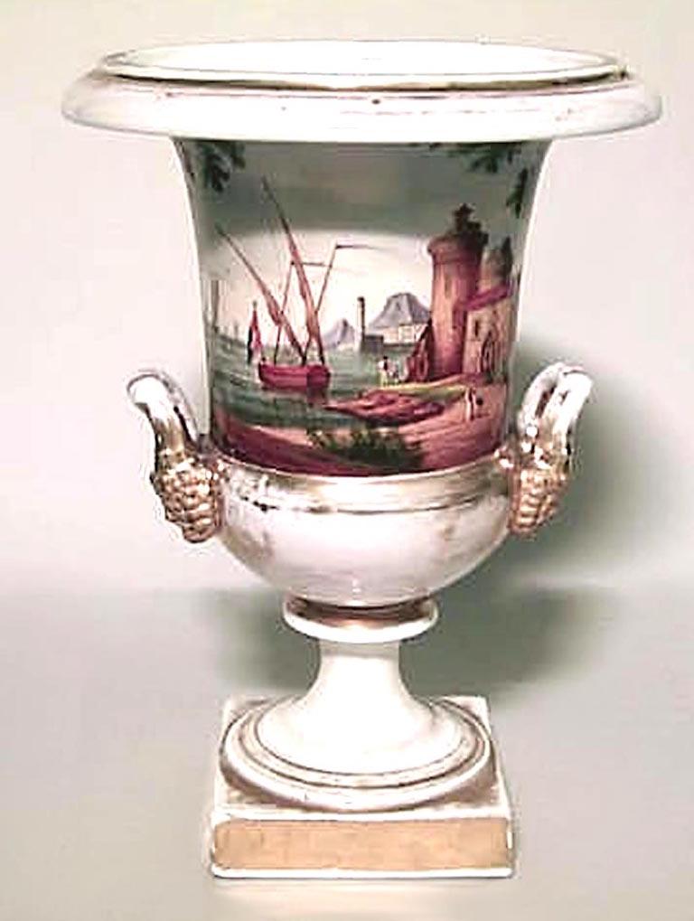 French Empire style (19th Cent) white and gilt trimmed urn with scene of boats by coast and 2 handles with lion heads.
