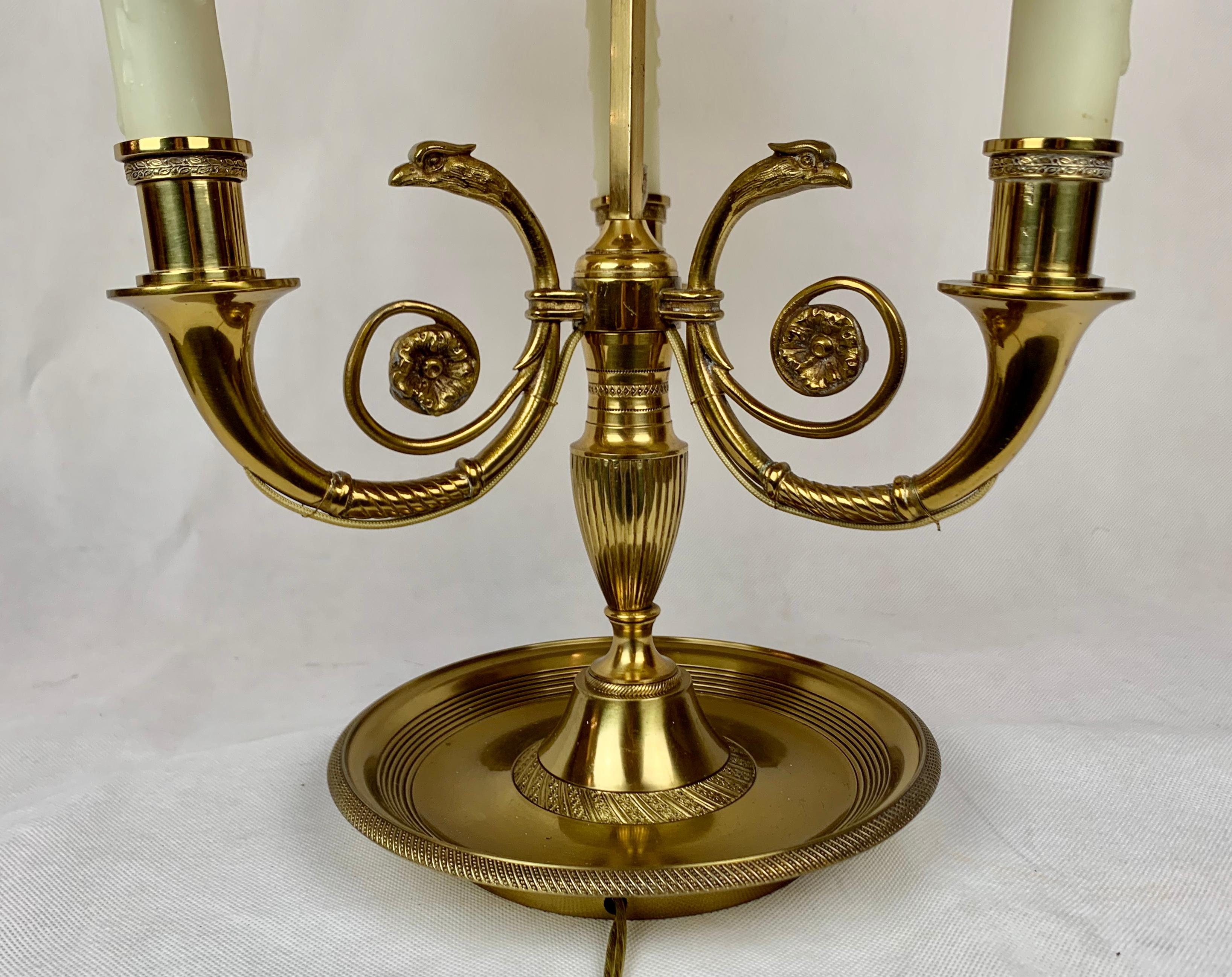 Three-light bronze bouillotte lamp with a black tôle shade in the French Empire style. The shade raises and lowers to adjust the light. Bouillotte is a card game and the lamp was placed in the center of a bouillotte table, as the candles burned low