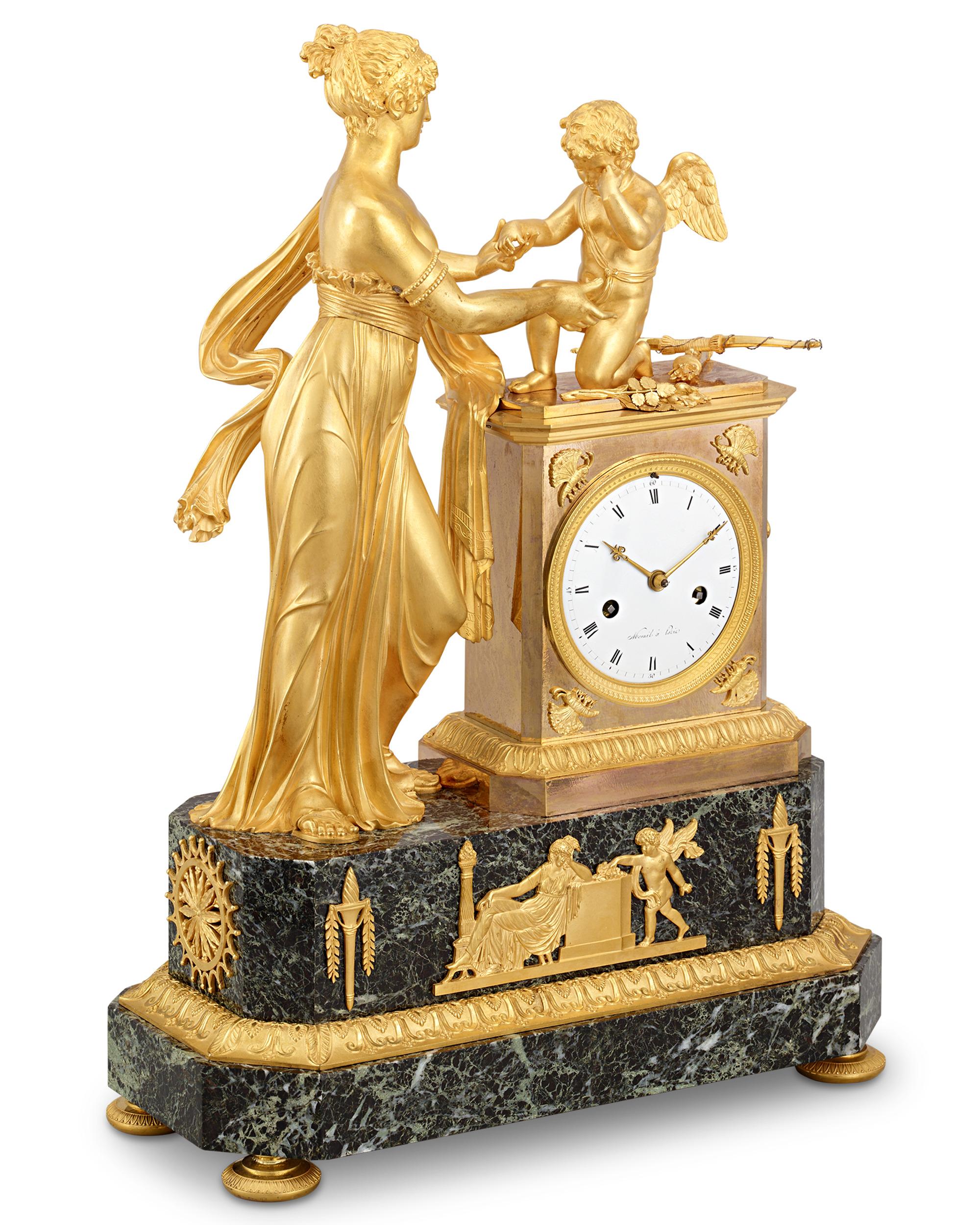 This splendid French Empire gilt bronze mantel clock features an exquisitely detailed scene of Venus and Cupid sharing a tender moment. Depicting the story of the goddess consoling her son after a bee sting, this tableau is a majestic display of