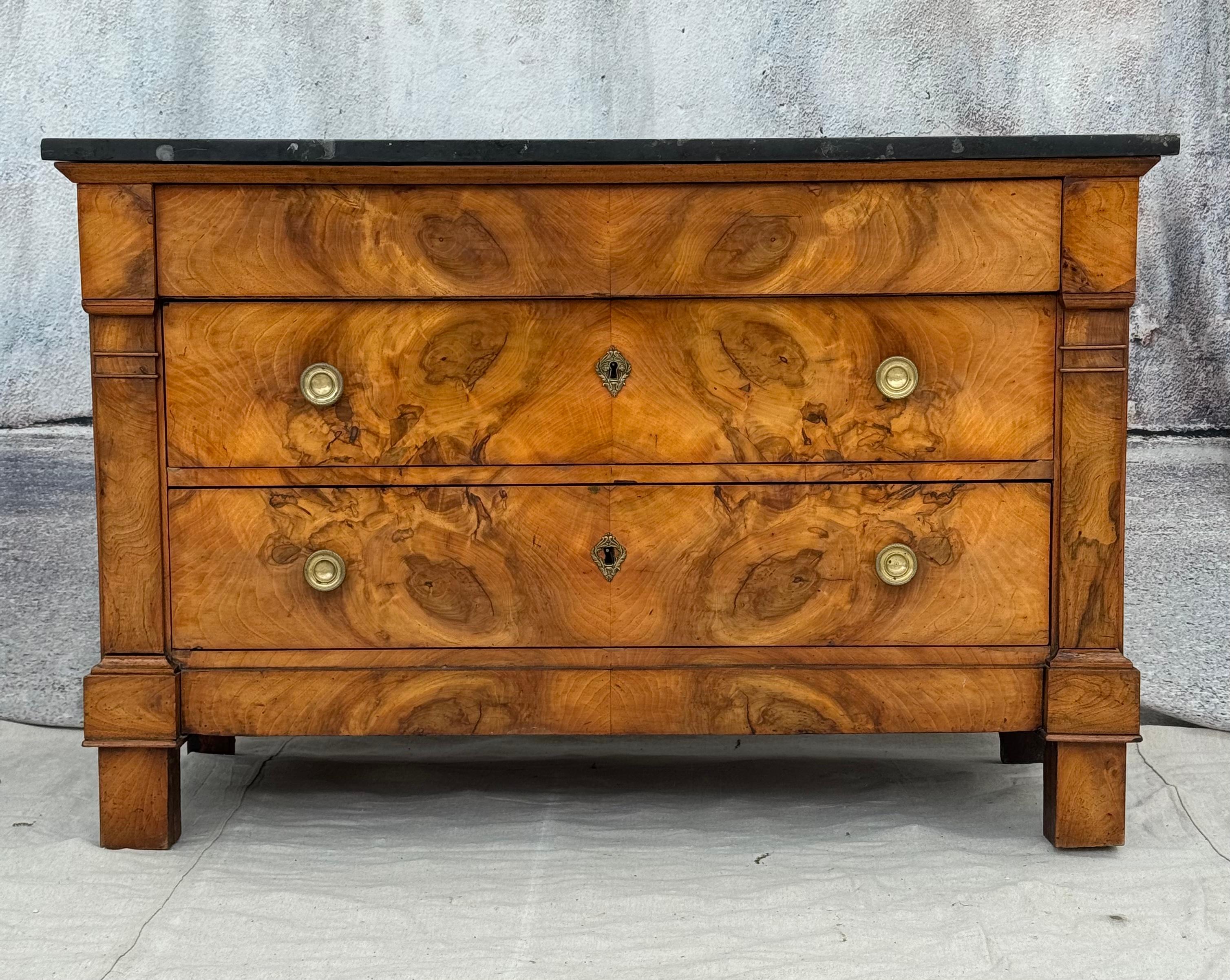 Elegant French empire style walnut chest with black granite marble top. Chest features a wonderfully figured burl walnut with three storage drawers with original brass hardware. Versatile chest can be used in modern spaces, as well as in classical