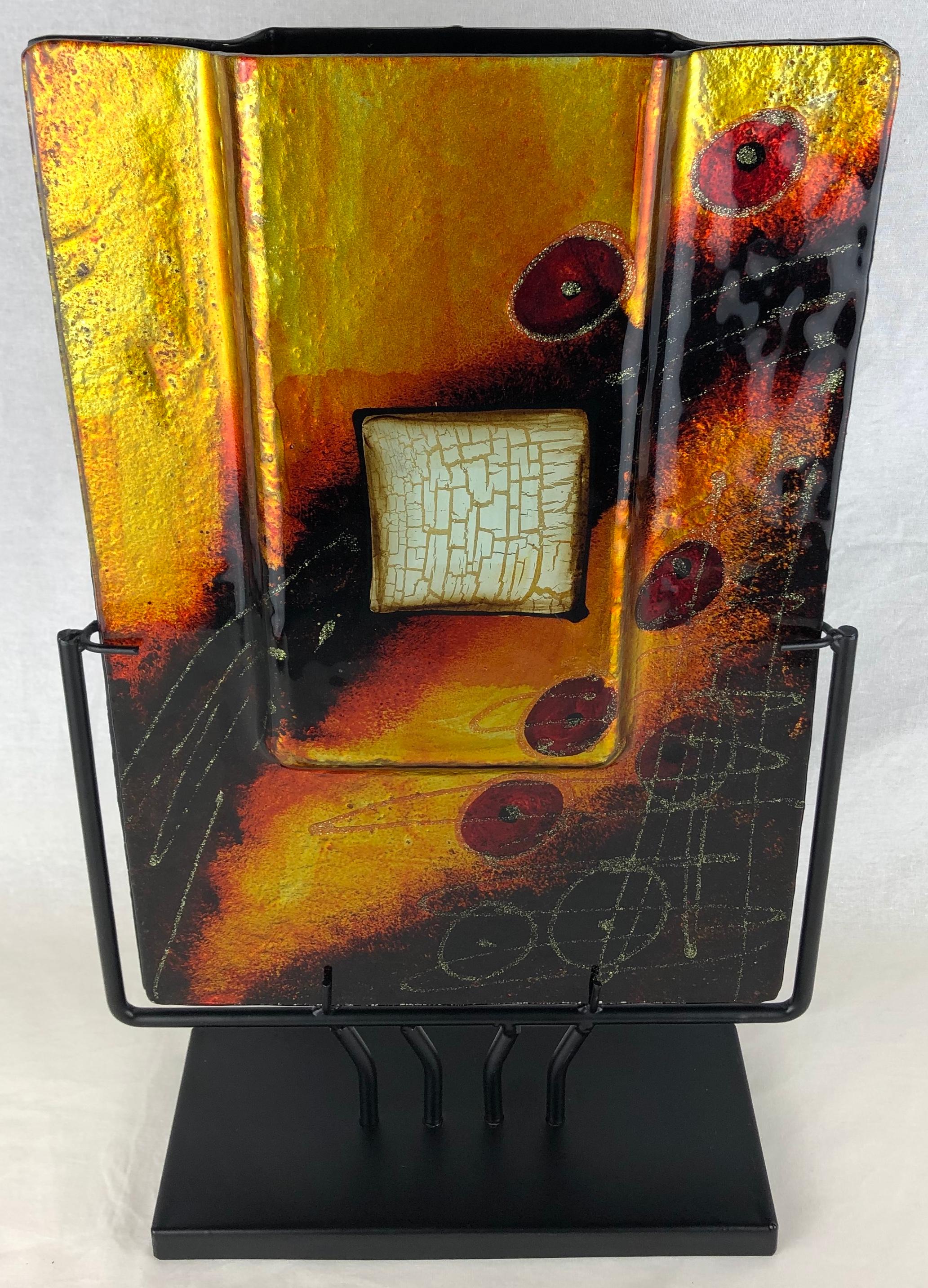 This beautiful decorative object features torched and crimped resin, welded and shaped metal which then received various patinated finishes. In this work the artist include a transparent resin in the center which creates a warm glow.

This