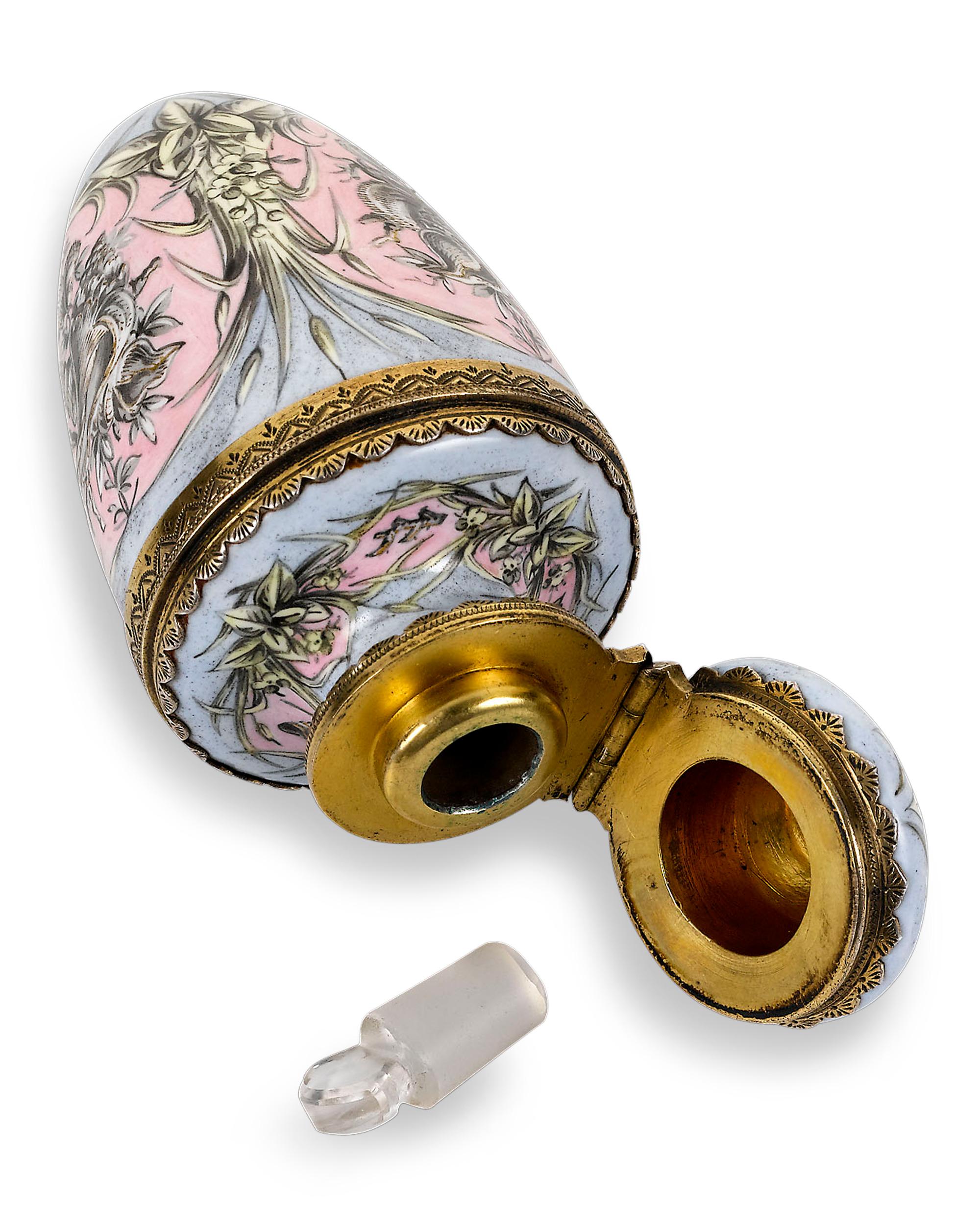 Exceptional enameling adds an elegant touch to this exquisite French perfume bottle. Crafted with fine yellow gold accents, this petite perfume is beautifully adorned with feminine pink and lilac enamel decoration in a delicate neoclassical style.