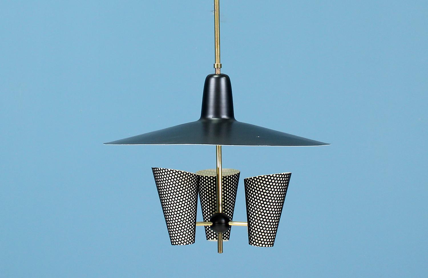 Dazzling ceiling light designed by Jacques Biny for Luminalite Edition in France, circa 1950s. A clean and simple design with a black enameled metal shade and three cones held by a ball joint arm with a brass structure. The mix of textures and
