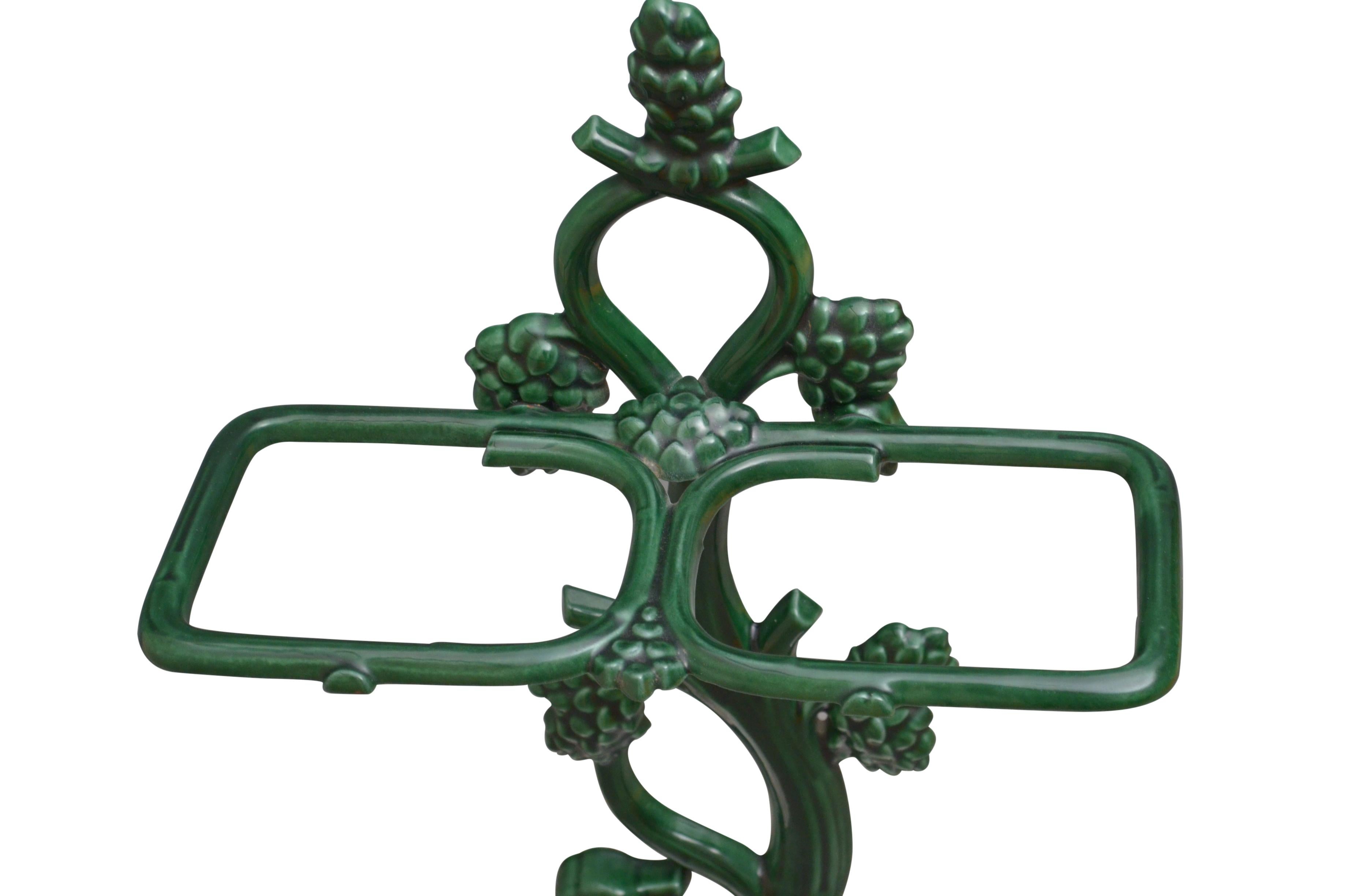 A stylish French cast iron umbrella stand retaining original green enamel and white enamelled tray and depicting a dog, all in excellent condition throughout, ready to place at home. c1930
Measures: H 27