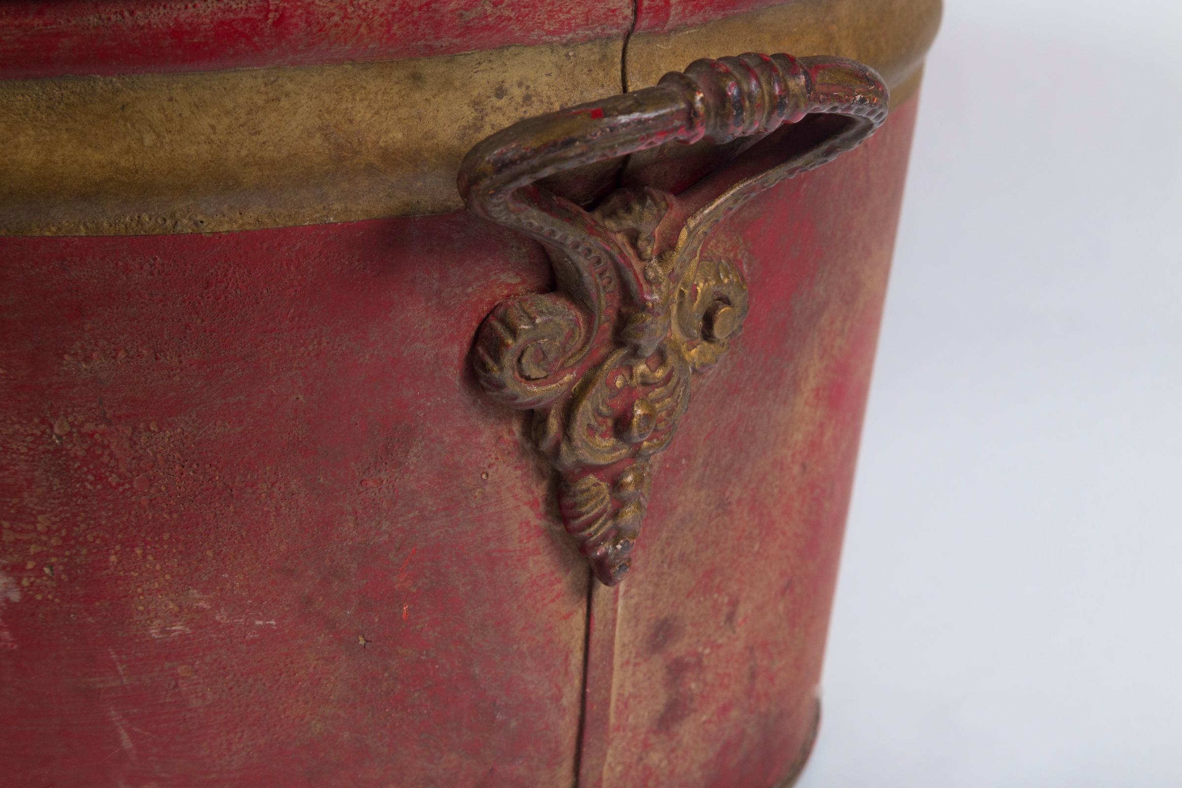 French enamelware basin, early 20th century. Aged red surface with gold banding. Wrought metal handles.