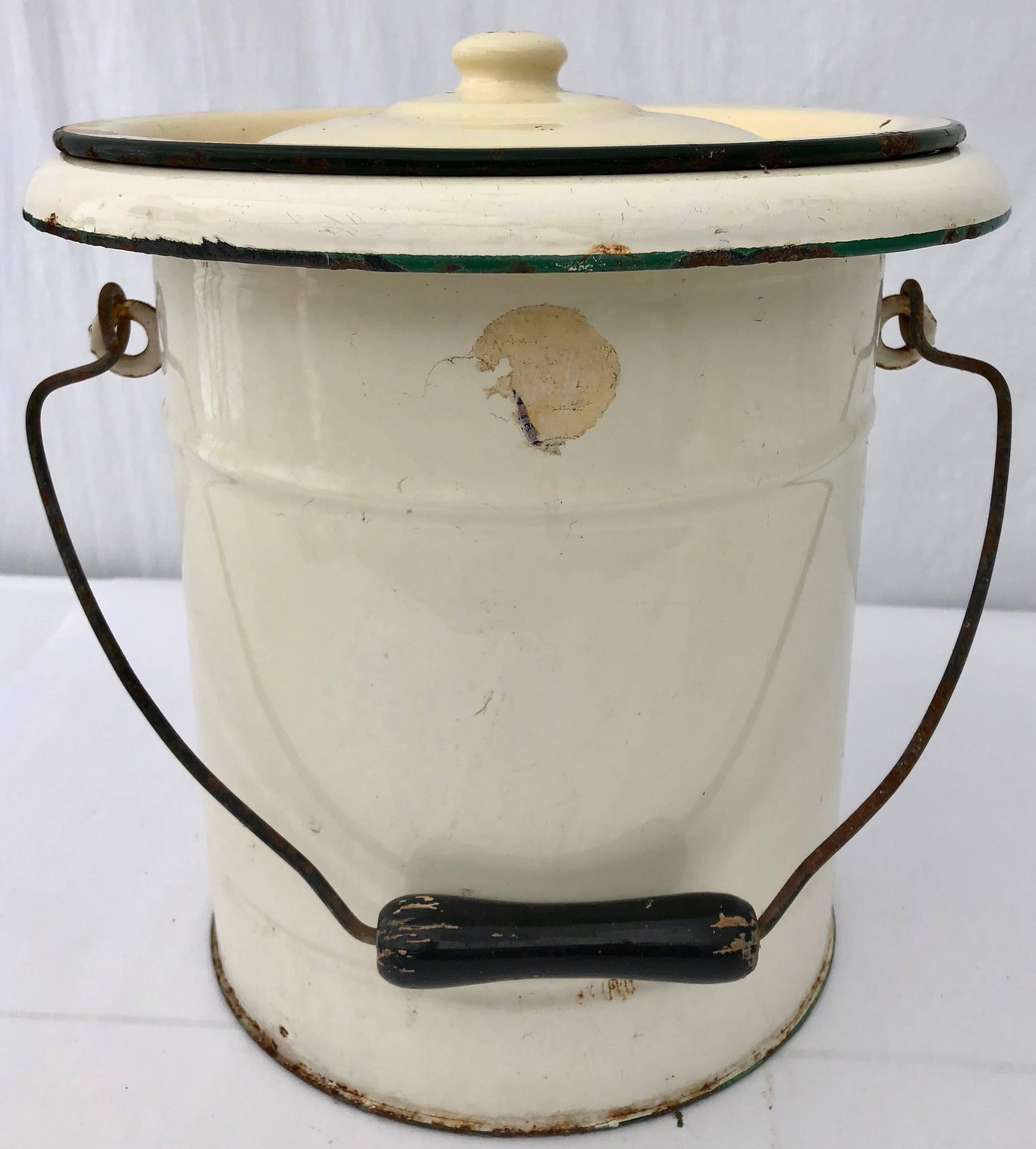 French enamelware tall cooking pot with lid, 1 articulated handle, yellow eggshell color. This piece would add a wonderful French touch to any room- add fresh cut flowers or place in a bathroom filled with clean rolled towels or use as a very unique