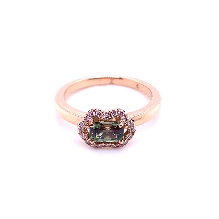 French Engagement Ring in Rose Gold with a Green Sapphire and Diamonds.
French Collection by Mesure et Art du Temps.

18 carat rose gold ring surmounted by a green sapphire 0.4 cm wide and 0.6 cm long.
The green sapphire is surrounded by 20