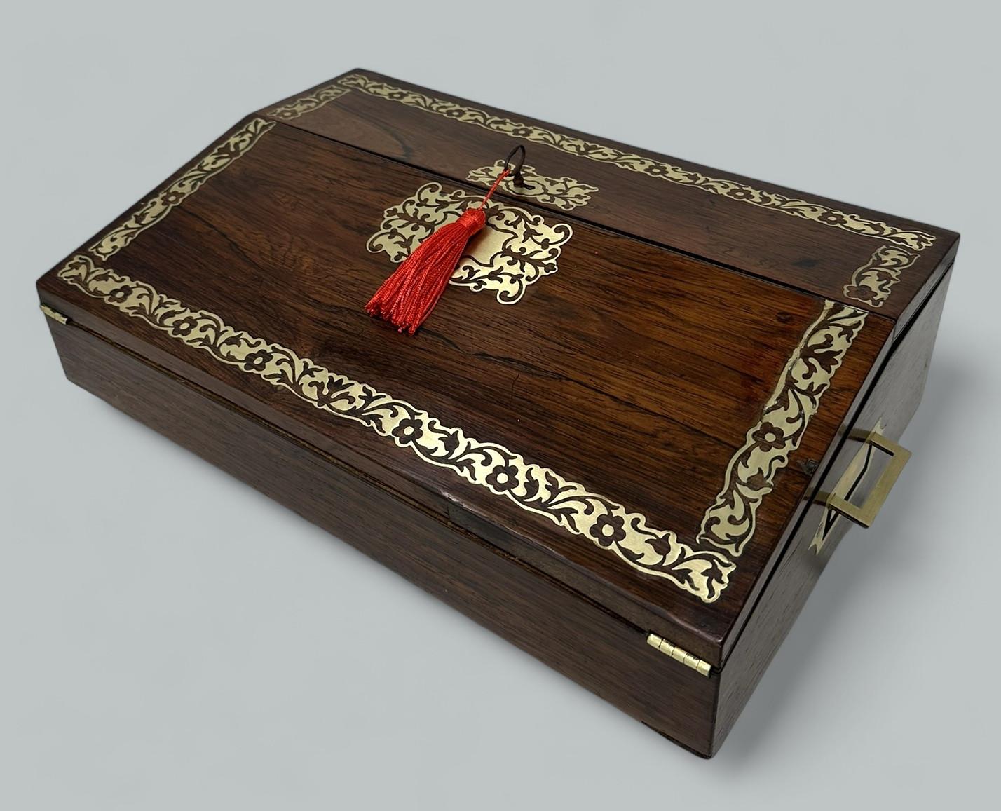 An Exquisite Example of an Early Rosewood Travelling Writing Slope of fairly large proportions of Continental origin, possibly French. Circa first half of the Nineteenth Century probably French Regency period. 

The entire main area with lavish
