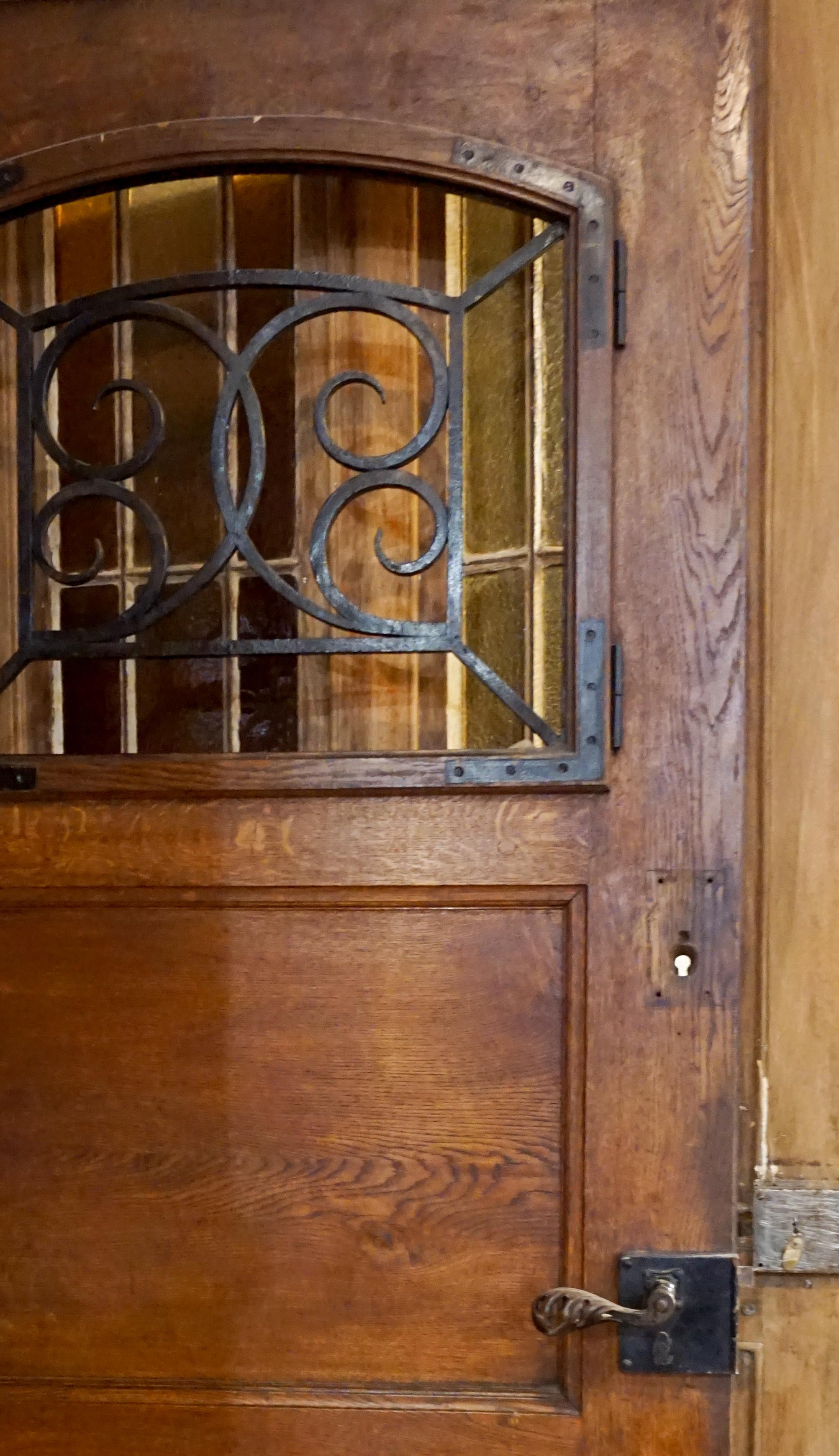 French oak single entry door. Arched top window with heavy ironwork.

Origin: France, circa 1880

Measurements: 41