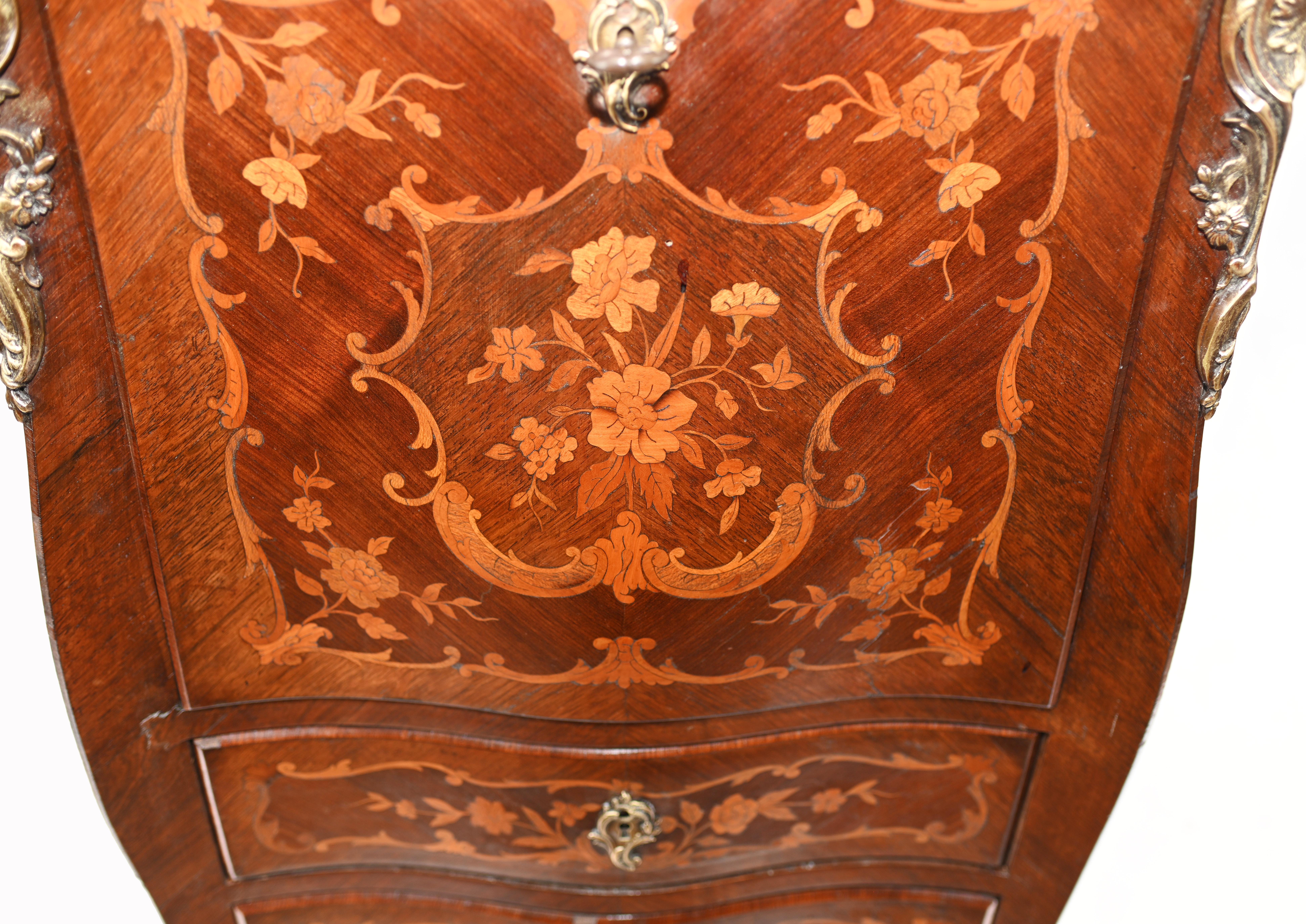 Gorgeous French Empire escritoire desk with intricate floral inlay
Classic piece of space saving French furniture
Desk writing surface opens out to reveal leather topped writig surface and various cubby holes
Intricate floral marquetry inlay on all