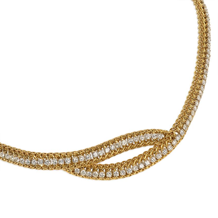 A woven gold and round brilliant cut diamond necklace of open bypass design, in platinum and 18k.  France.  Atw 8.00 cts.