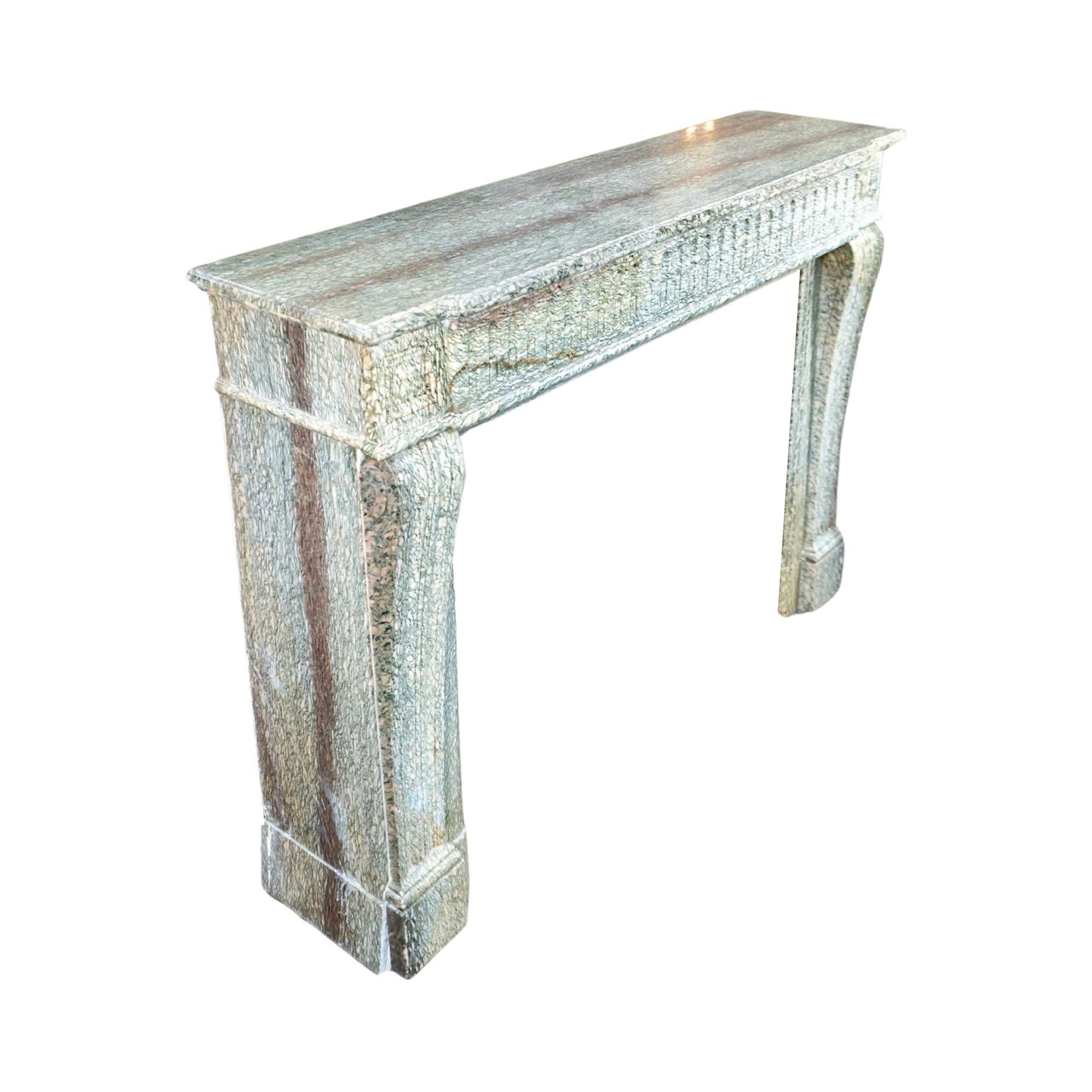 This gorgeous French mantel is crafted with the utmost expertise from Estours Green Marble, with intricate carvings in the distinctive Louis XVI style. A true antique from the 1880s, it celebrates the beauty of traditional French craftsmanship.