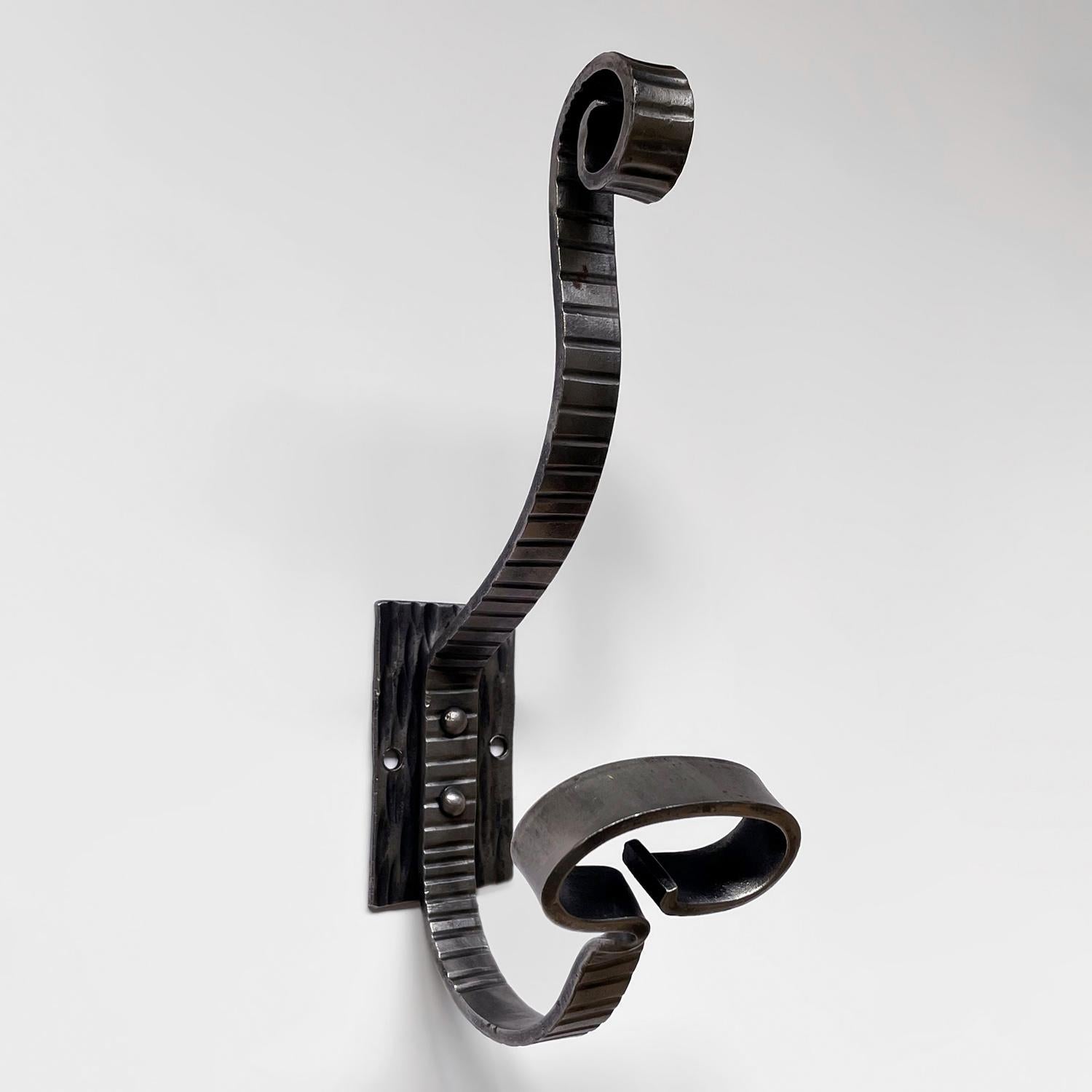 French etched iron double wall hook
France, mid century
Beautifully sculpted flat iron J hook finished with curved iron detailing
Wide loop lower hook and spiraled iron upper hook
This piece has many fun details including the intricate etched
