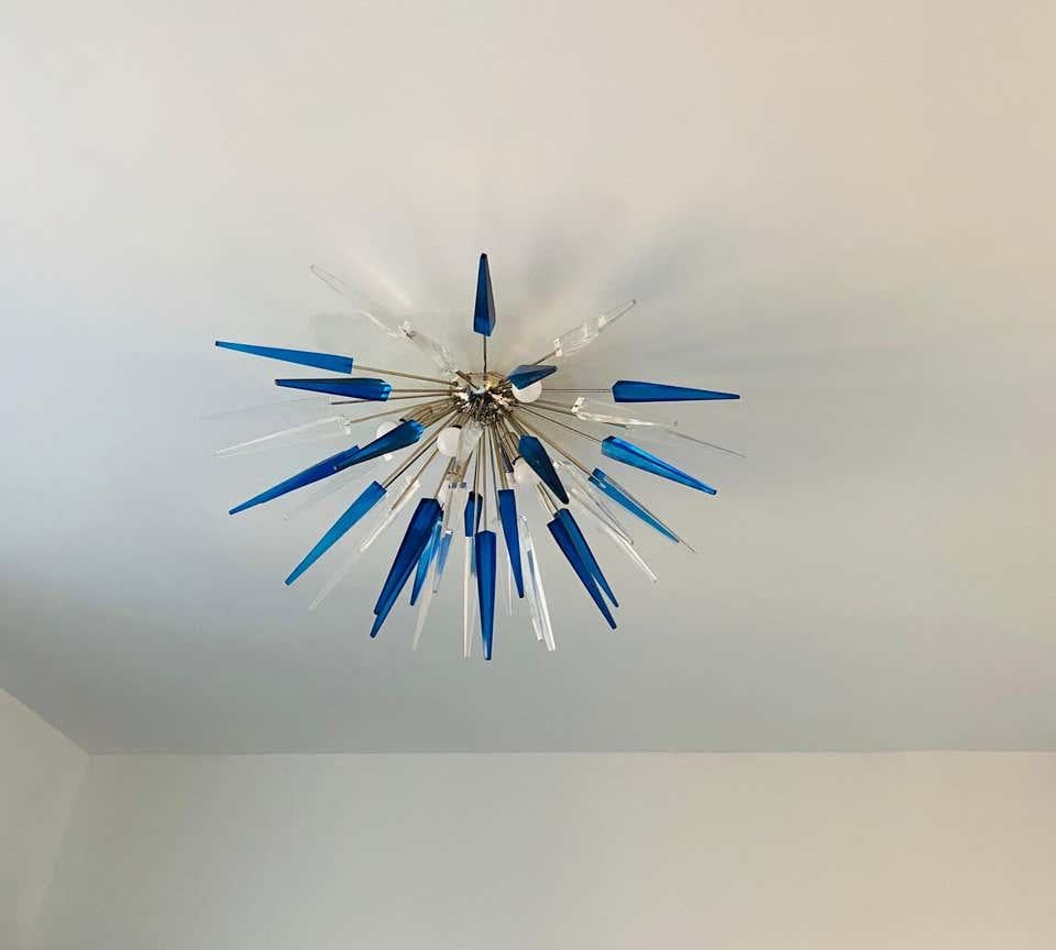 A powerful French statement piece done in polished chrome and clear and sapphire blue resin spears. Rewired. We can place it on a ceiling pole to be used as a pendant at no additional charge.