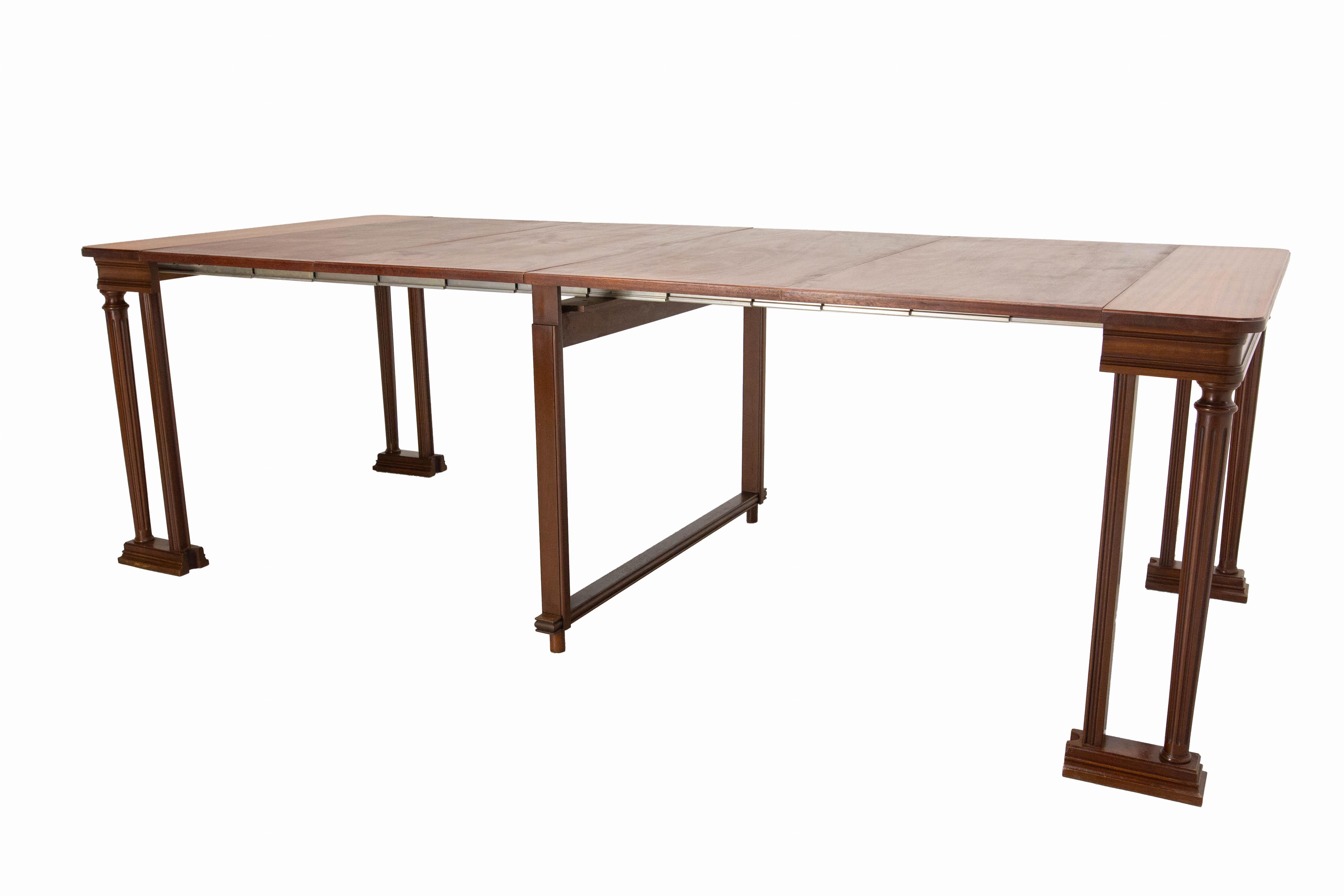 Dining table or conference table, French, circa 1970
Exotic wood and steel
When folded, the table measures only a few centimetres, which is very useful for multi-purpose rooms and it can be used as a console
Dimension D 39.37 in. W 16.54 in.  H