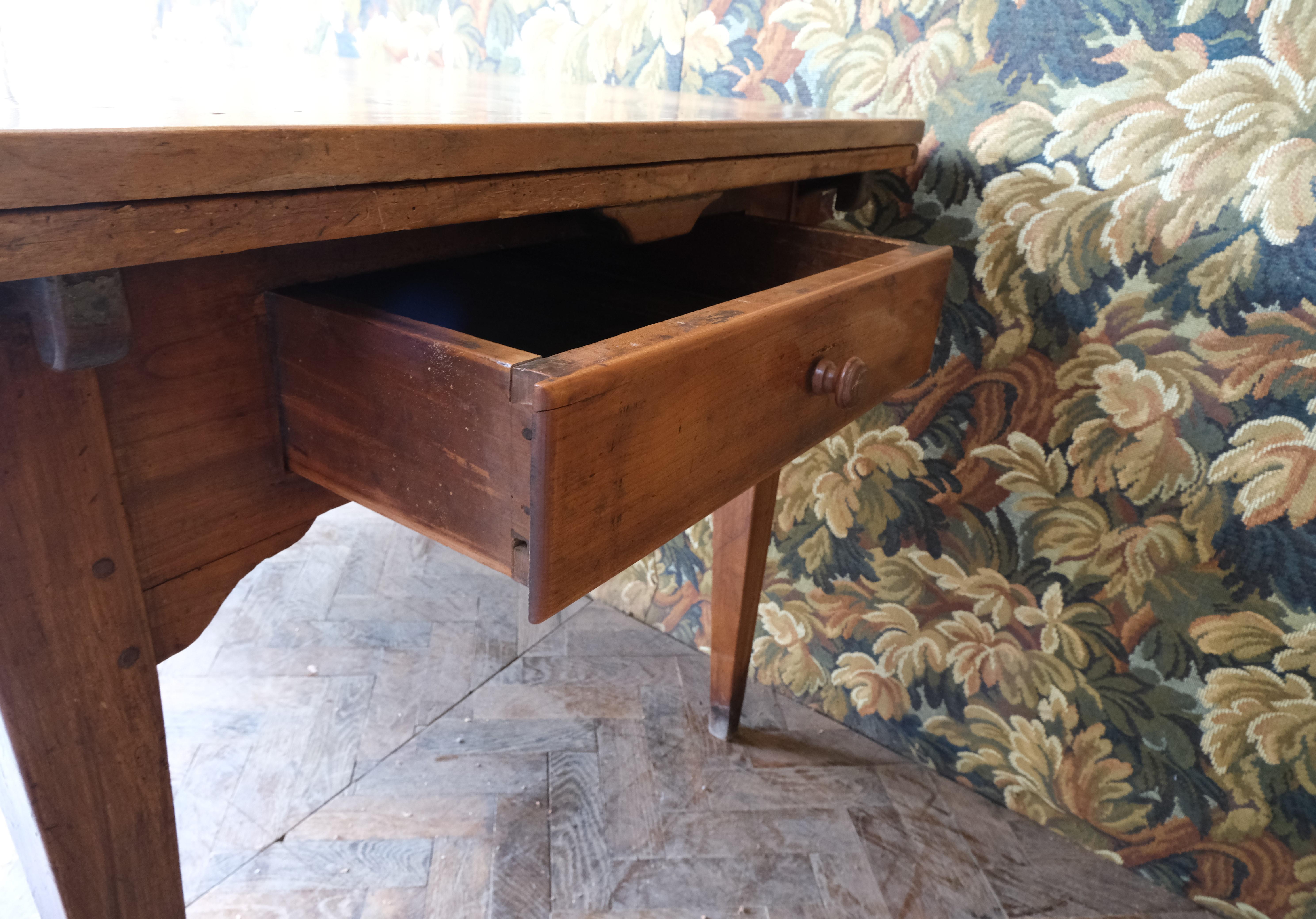Hutton-Clarke Antiques is pleased to offer a wonderful French 19th-century cherrywood farmhouse table. Notable for its extending capability, the table can be adjusted from a length of 1.60 metres to 3 metres. It stands on tapered legs and has a