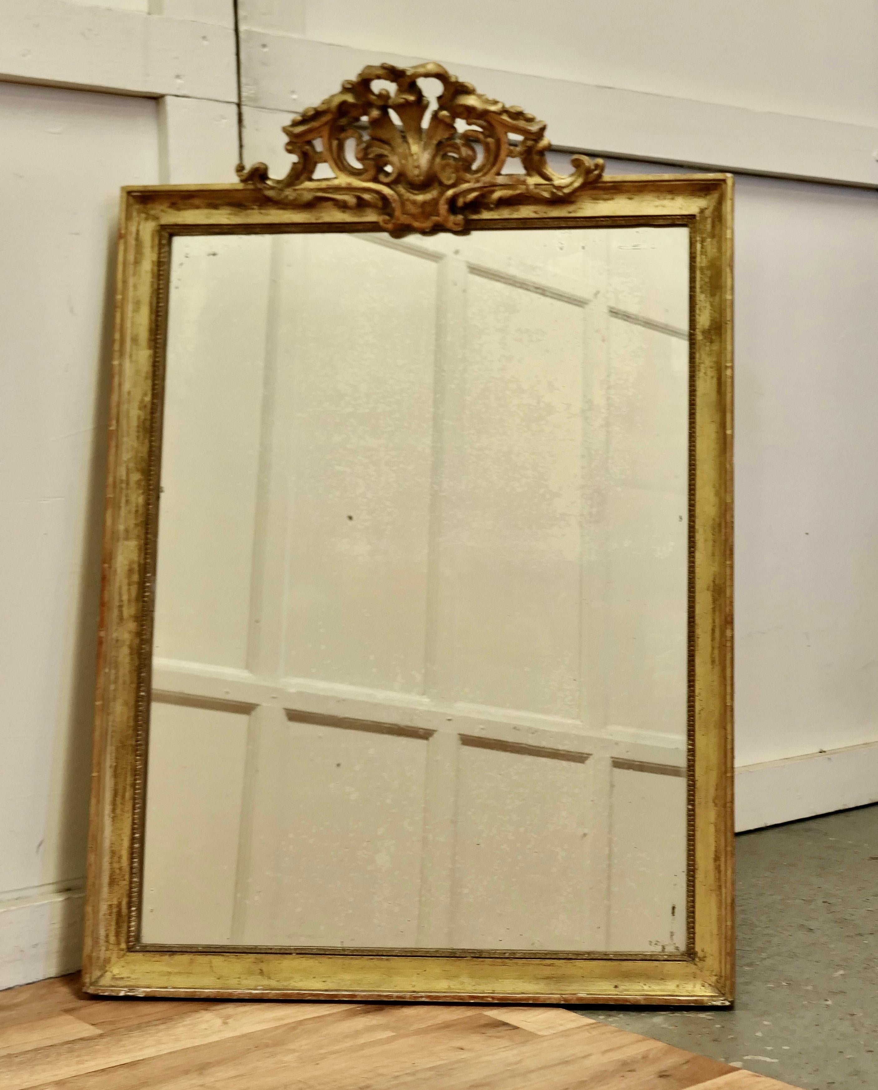 French faded pale gilt Pier mirror

The mirror has a very elaborate large pierced top decoration which hangs over the slightly shabby pale faded gilt frame, it is in good condition
The mercury glass as a slightly mottled foxing all over and there