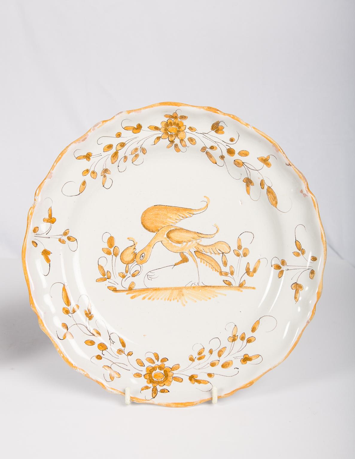 We are pleased to offer these two 18th century French faience dishes painted with figures. The first plate, mustard yellow on a white ground, features an amusing stylized bird. The second plate light green on a white ground shows the 