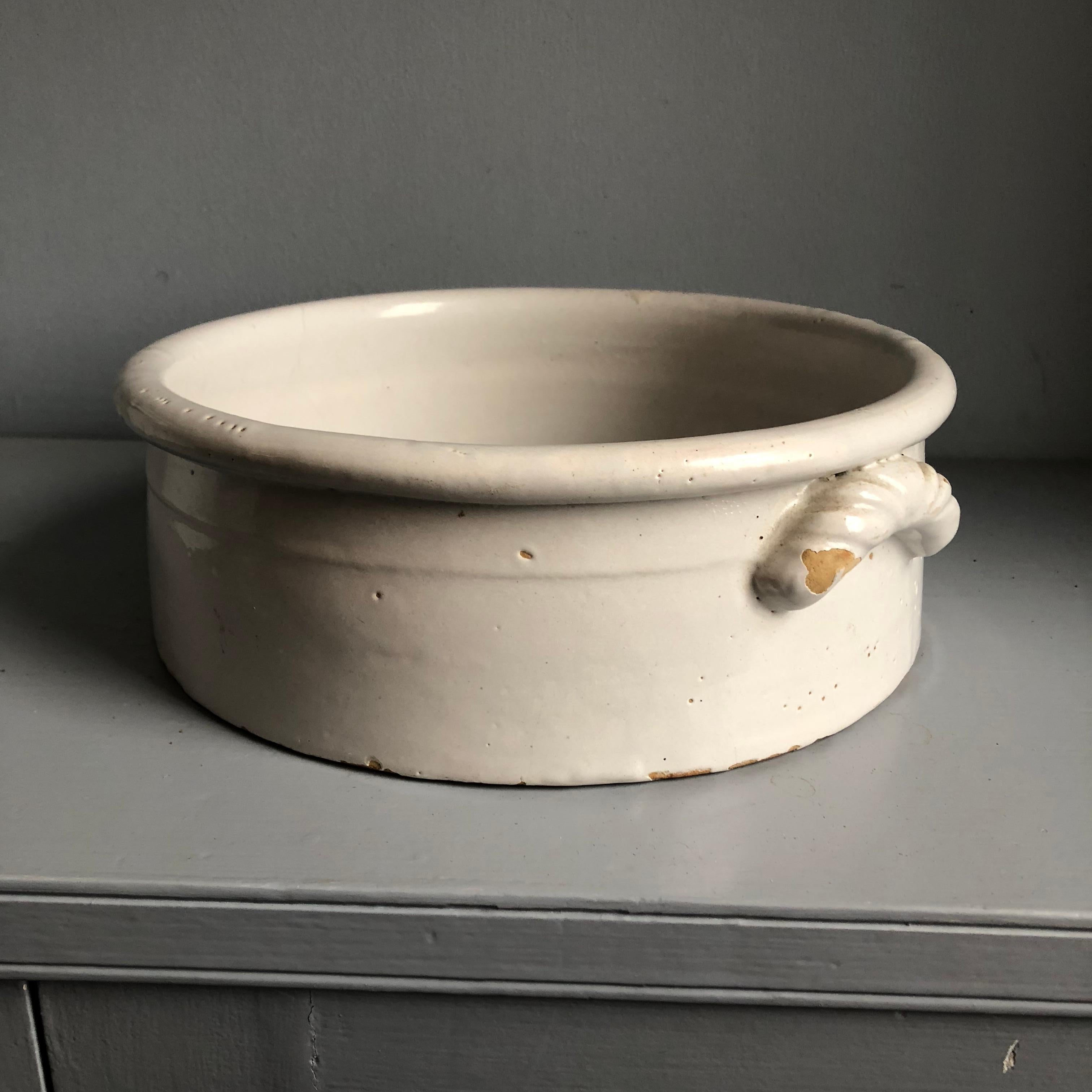 A white glazed ceramic “cachepot” with braided handles, French, circa 1870.
