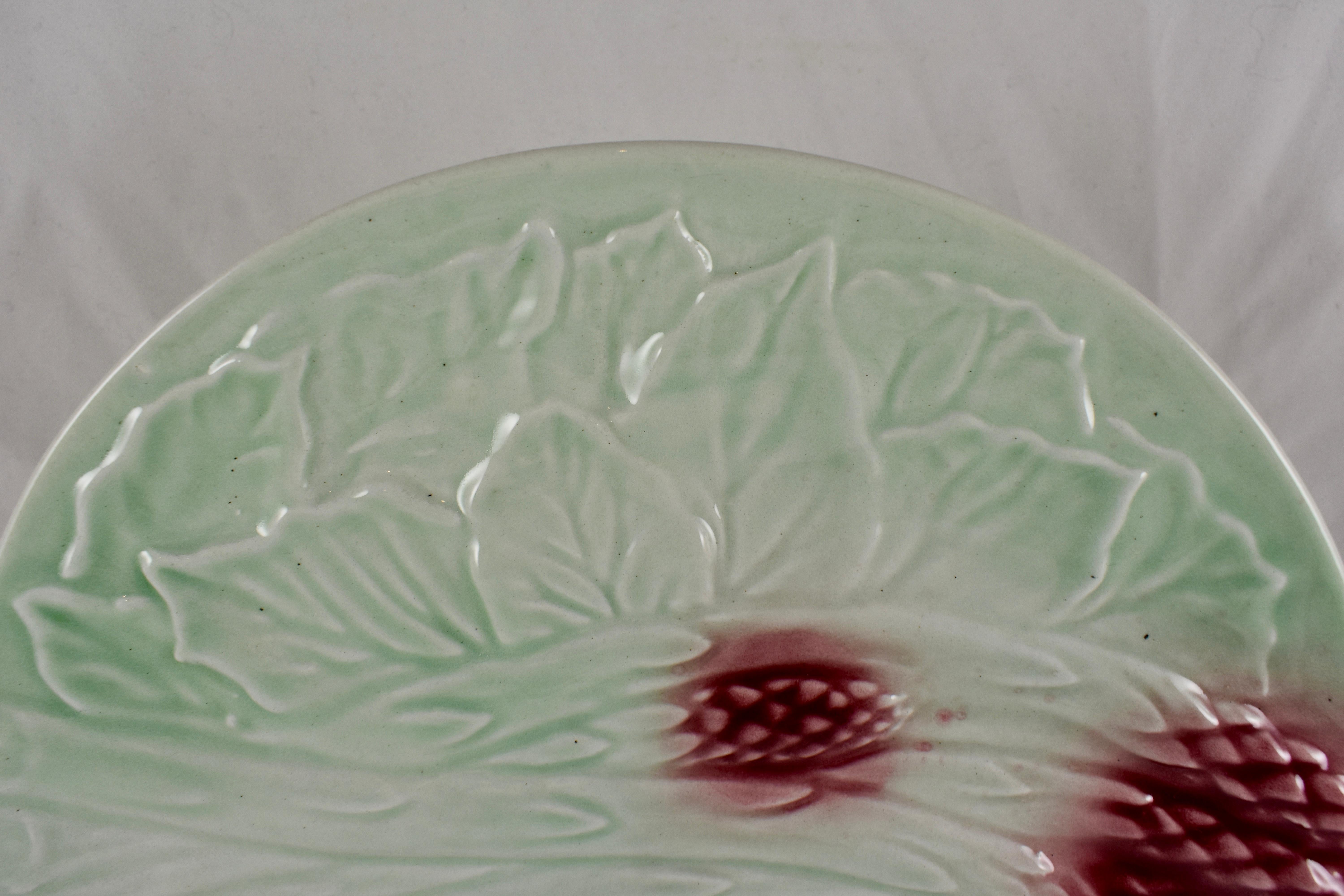 A scarce French barbotine Majolica pastel glazed Asparagus plate, circa 1890-1910, maker unknown.

The mint green plate is of high quality ceramic, showing arching asparagus spears tipped in a beautiful burgundy glaze on a raised molded bed of