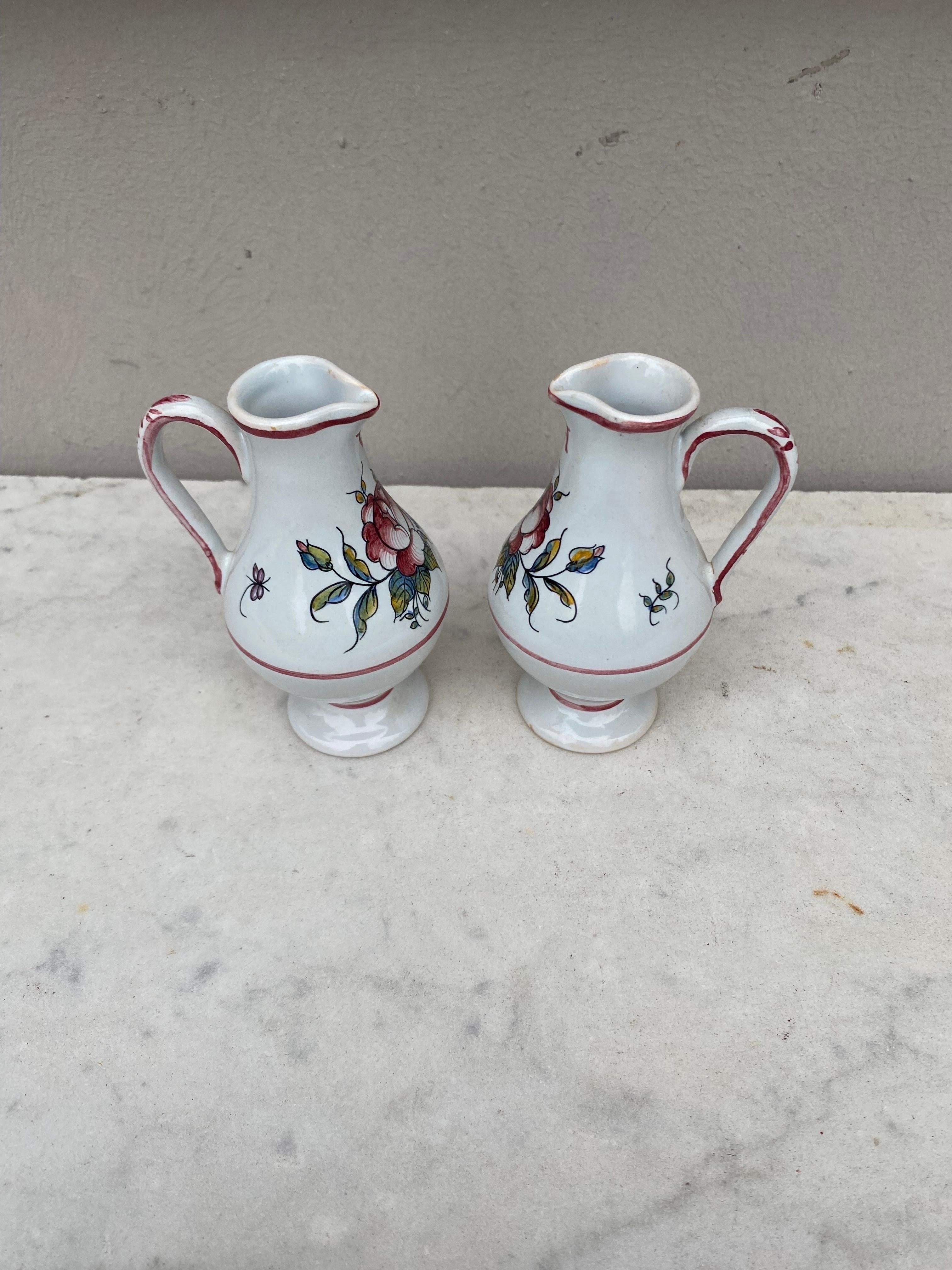 Pair of antique French faience oil and vinegar pitchers, circa 1900. Unsigned. Minors chips.
Decorated with roses.