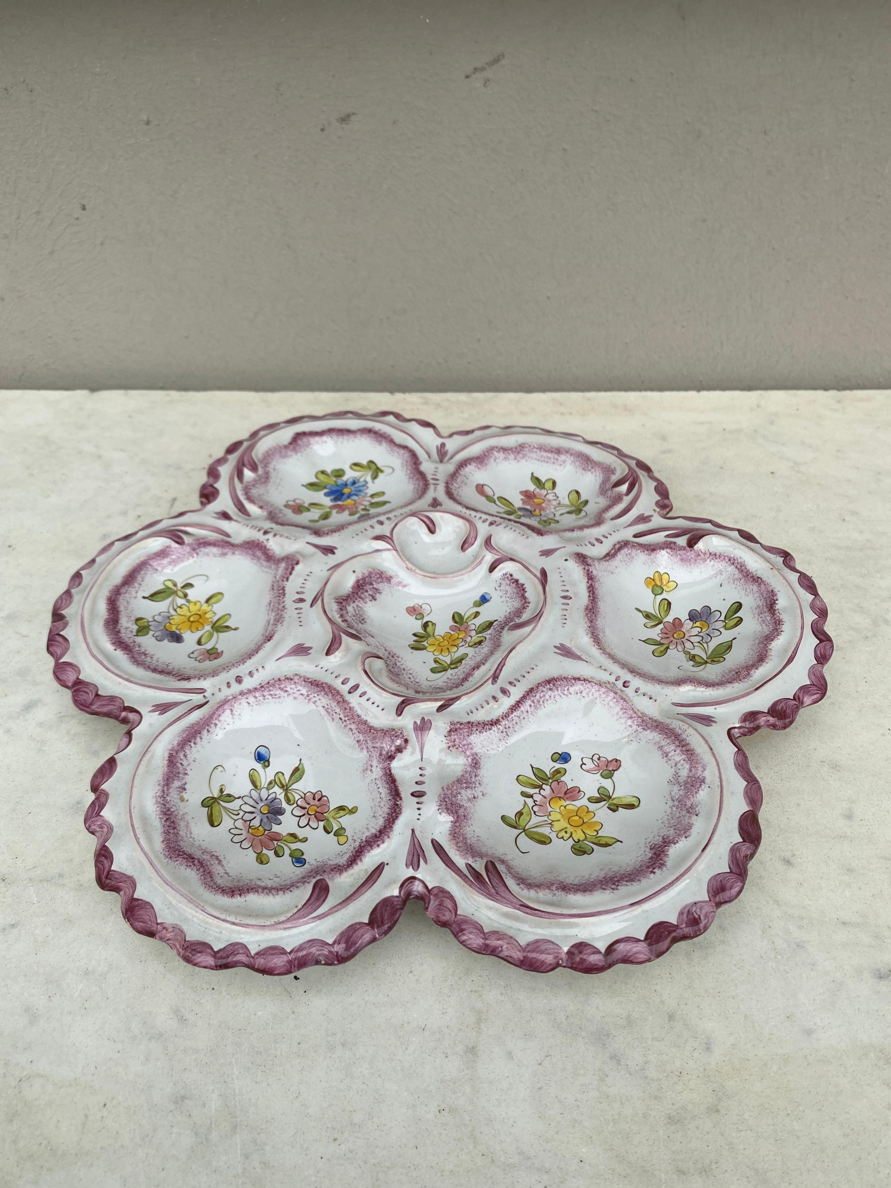 Lovely large French faience oyster plate in pastel colors with flowers, circa 1900 signed Alfred Renoleau Angouleme.
