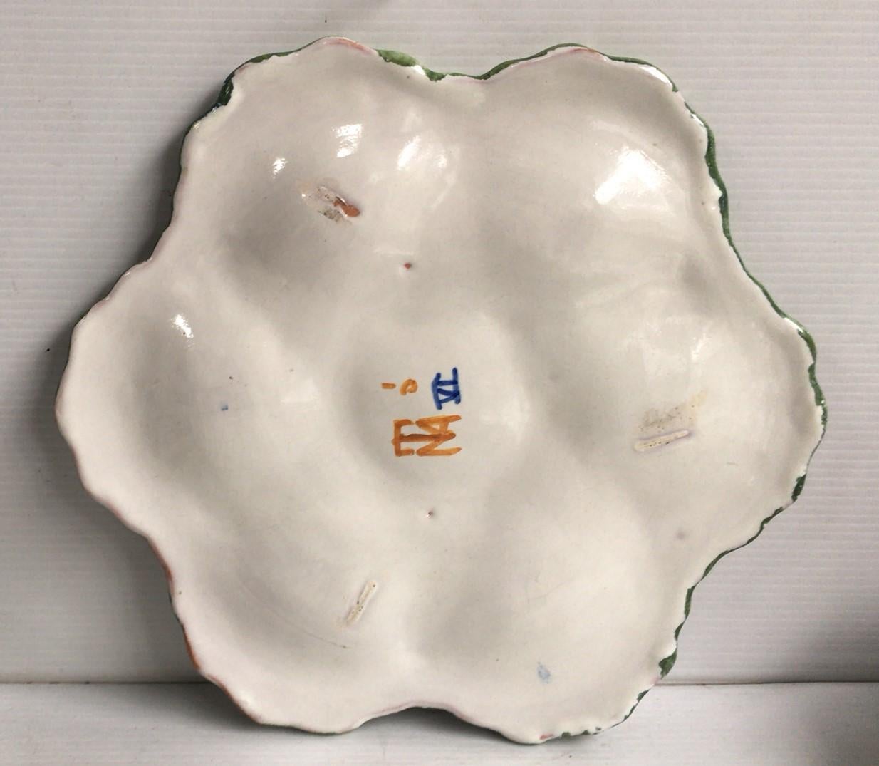 French Faience rustic oyster plate Moustiers style, circa 1940.
Painting of flowers and bird on the center.