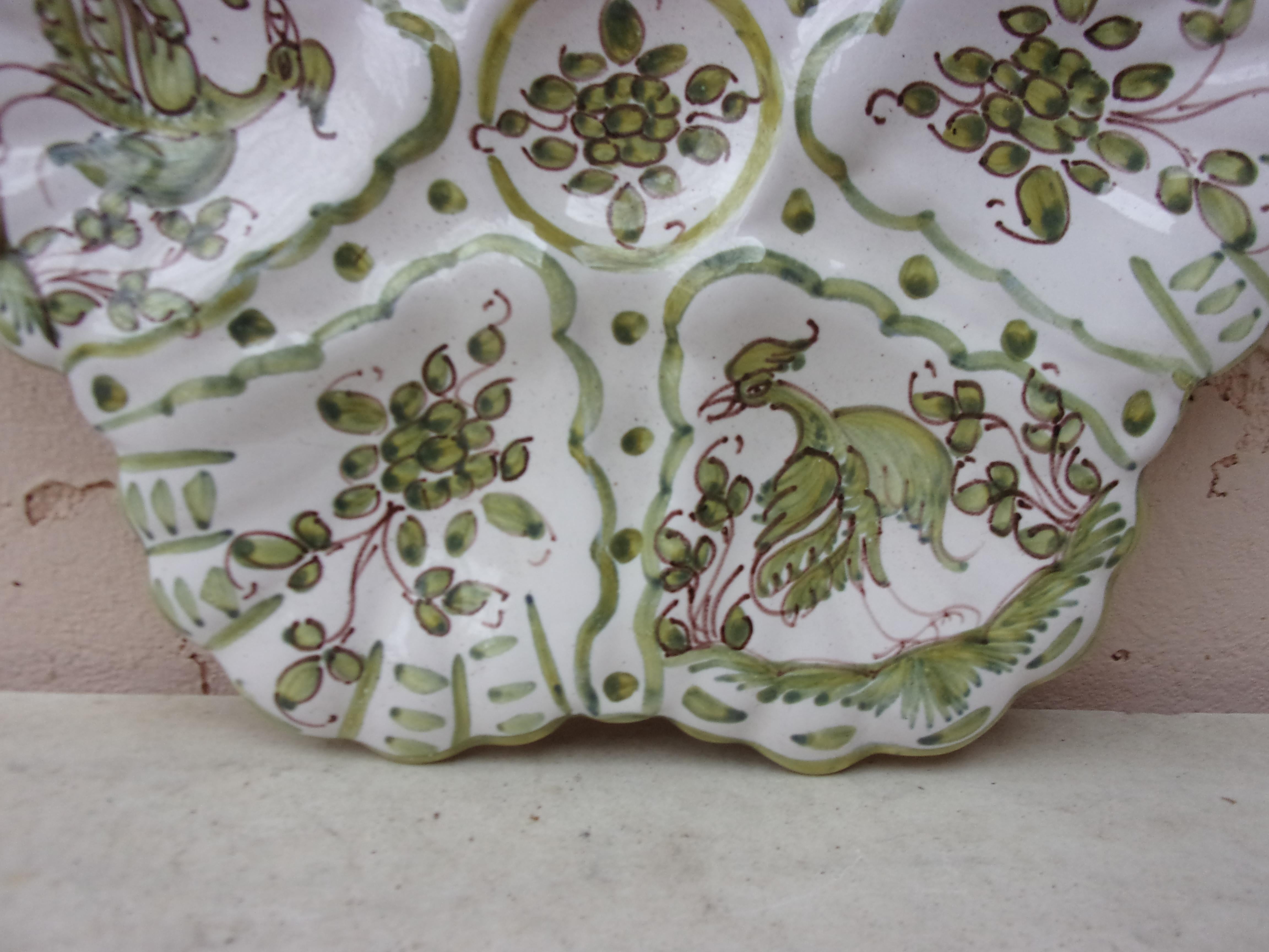 French Faience rustic oyster plate Moustiers style, circa 1940.
Painting of birds and flower on the center.
