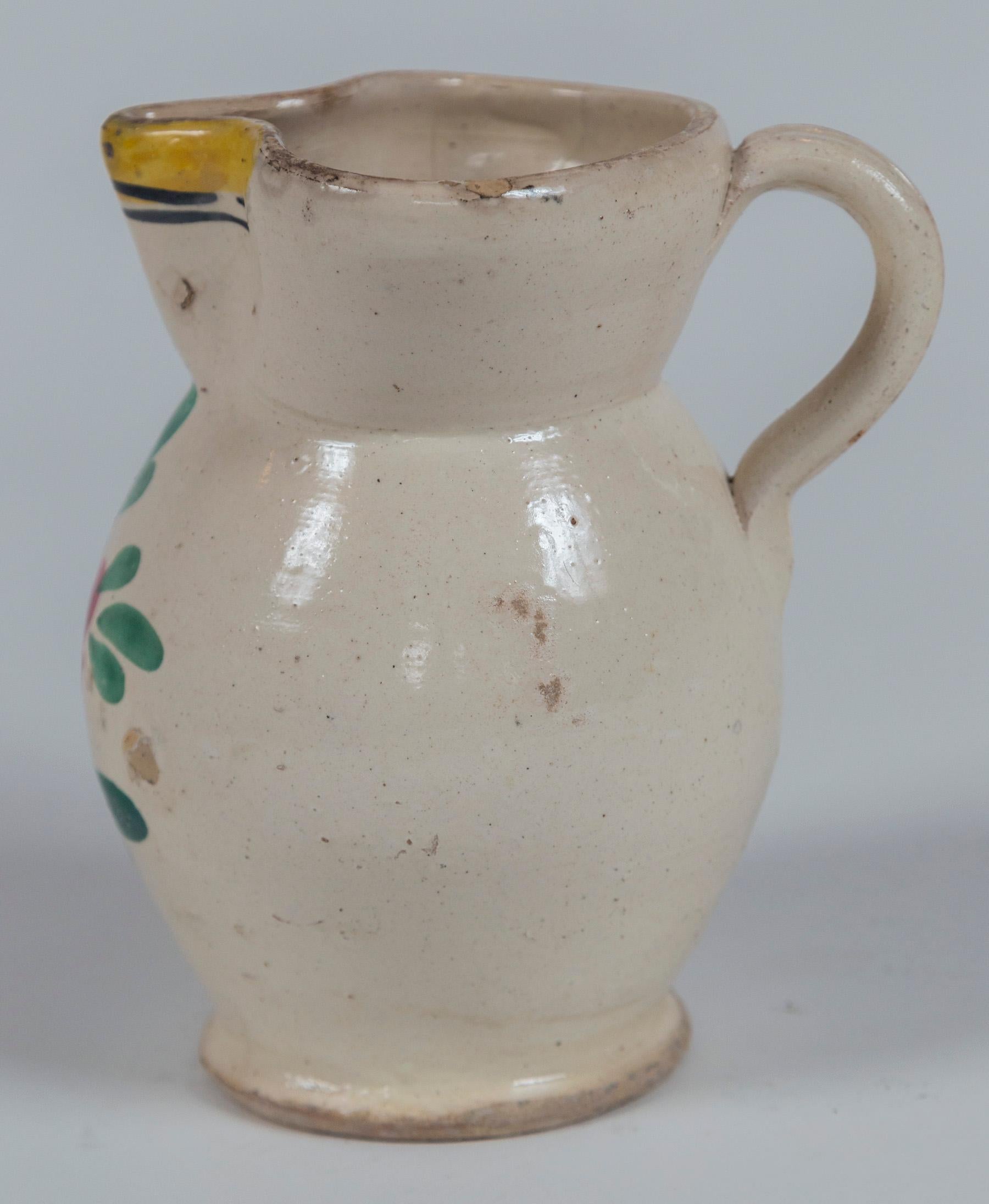 French Faience Pitcher, late 19th century. Hand-painted, traditional floral design.