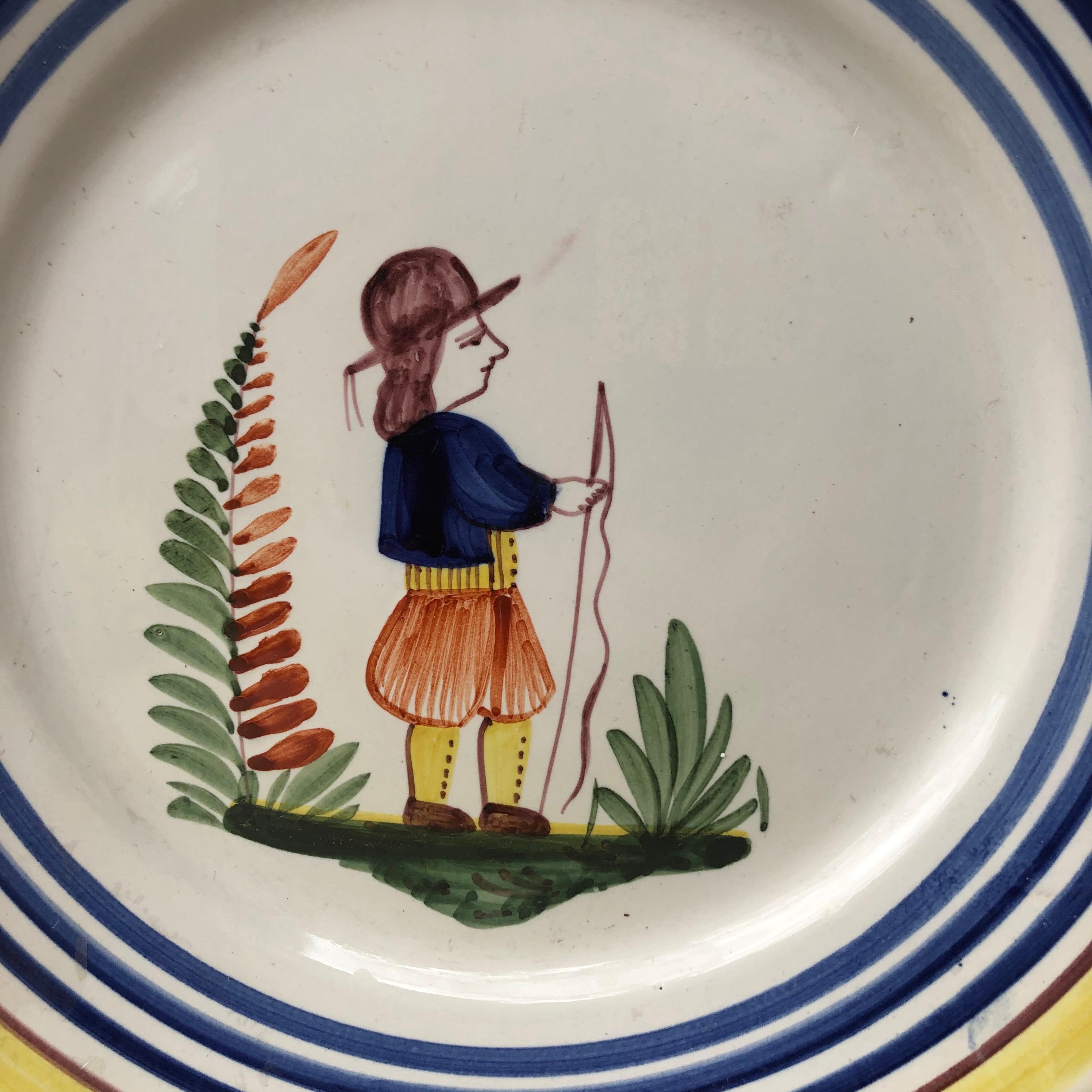 A French large faience plate with a farmer in the costume with flowers signed Henriot Quimper, circa 1950.
Colorful yellow border and blue lines.
Measure: 9.5 diameter.