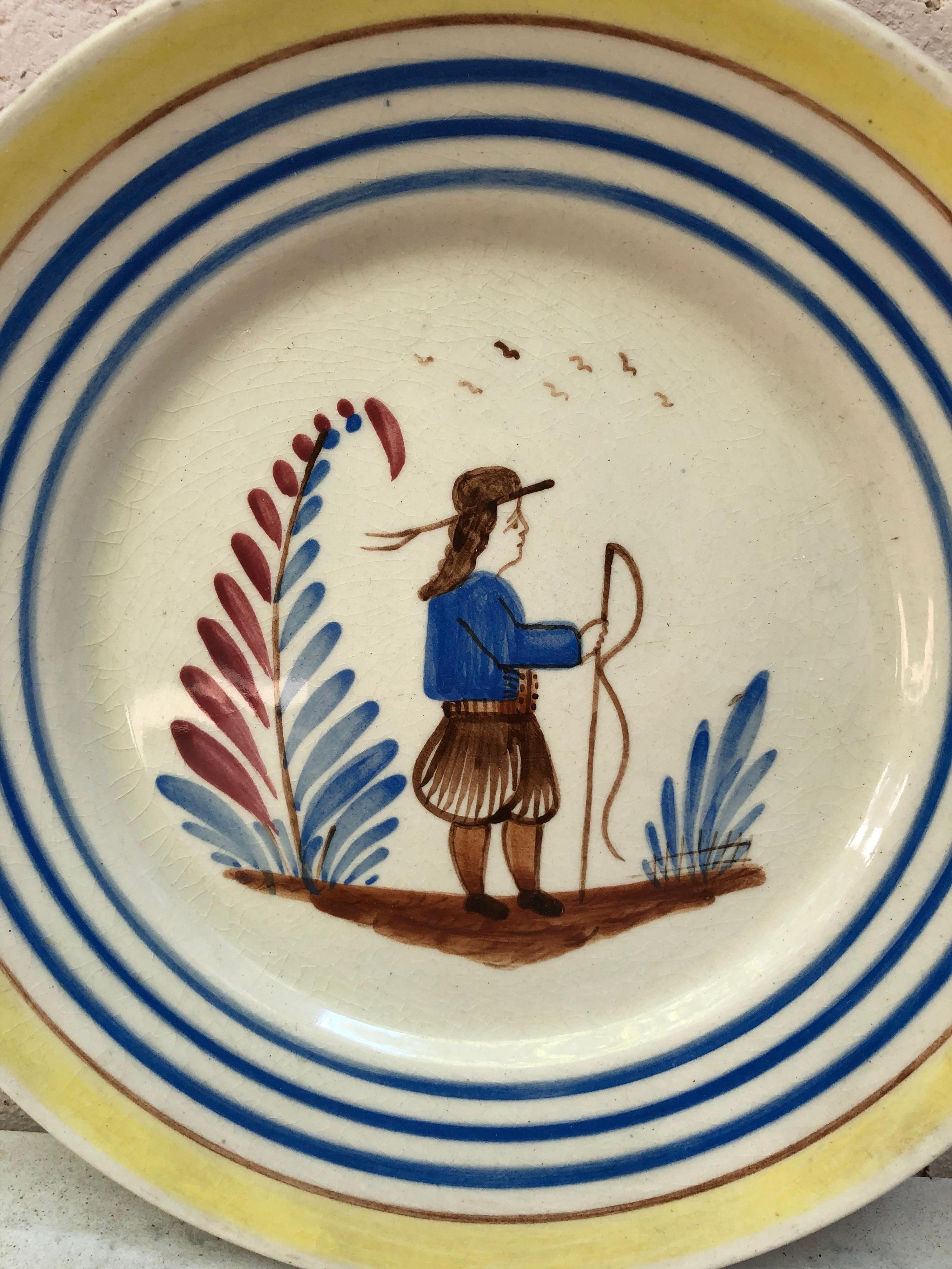 A French large faience plate with a farmer in the costume with flowers signed Henriot Quimper, circa 1950.
Colorful yellow border and blue lines.
Measure: 9.5 diameter.