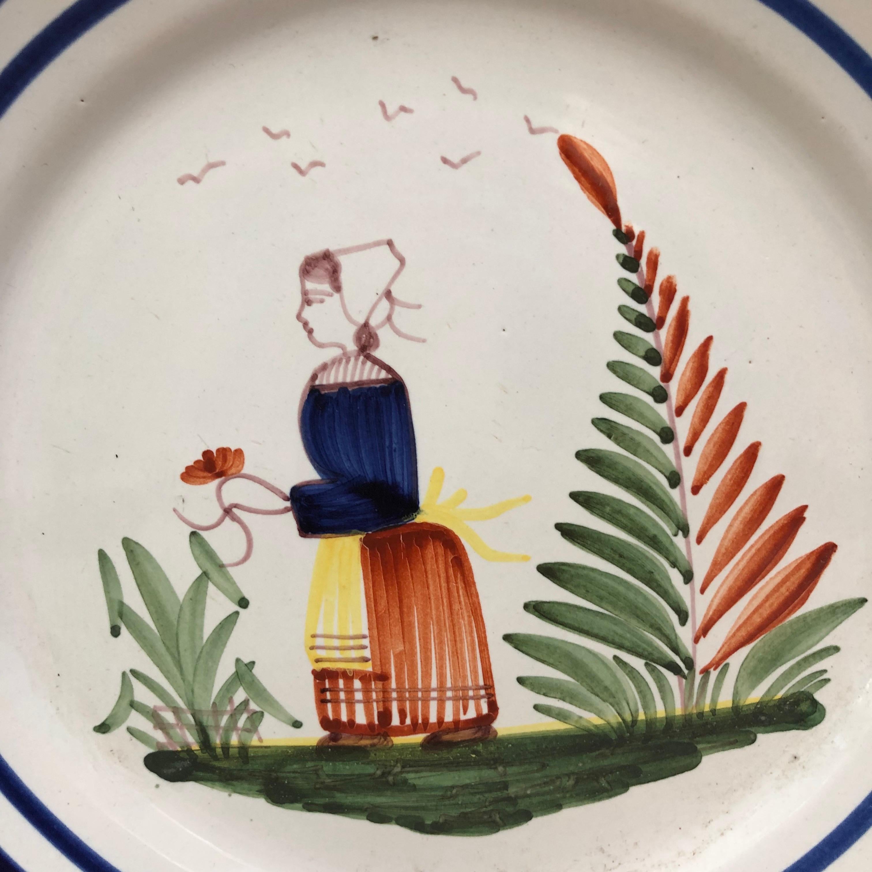 A French large faience plate with a farmer in the costume with flowers signed Henriot Quimper, circa 1950.
Colorful yellow border and blue lines.
Measure: 9.5 diameter.