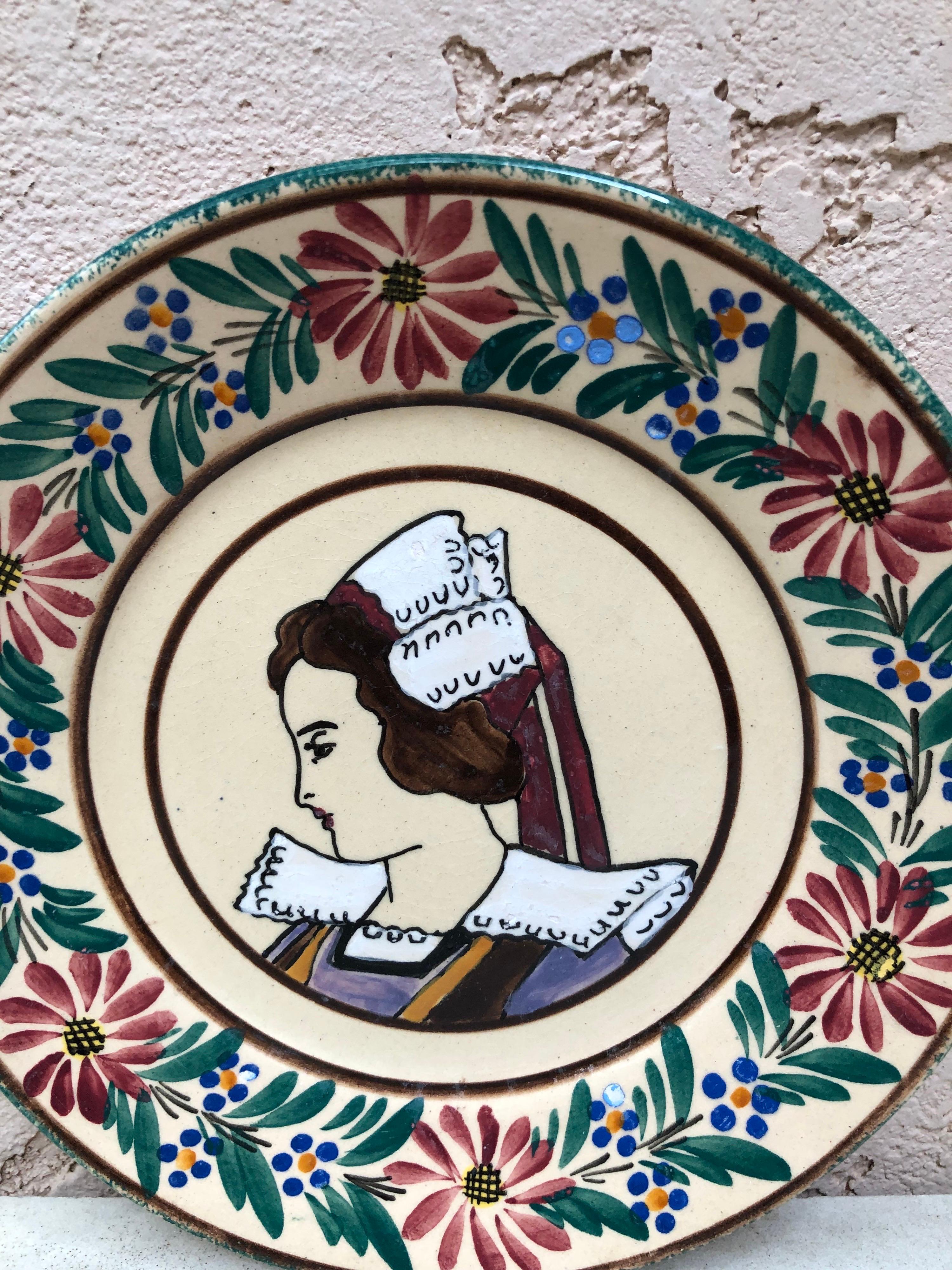 French faience plate Quimper, circa 1920
Border with flowers, representing a woman with the traditional costume of Brittany.