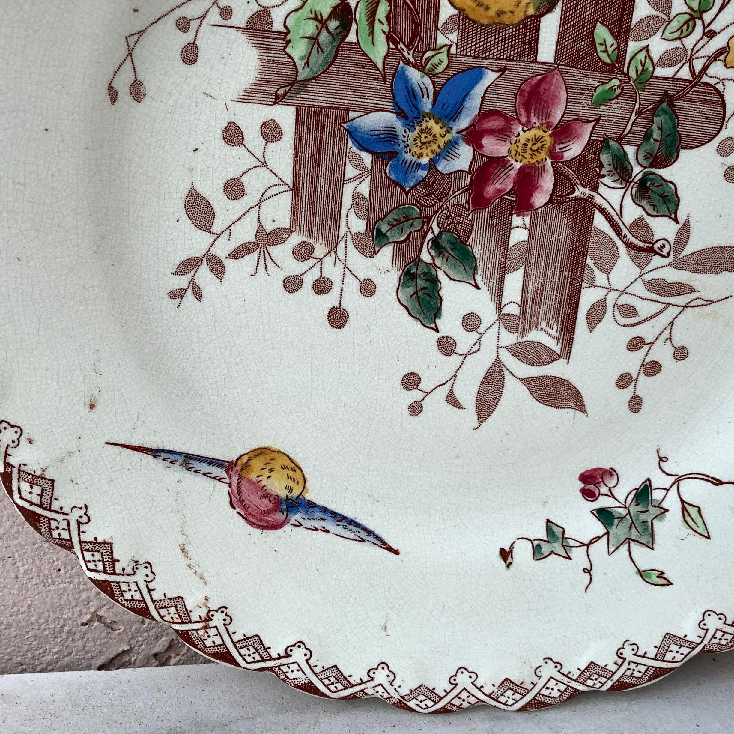 French faience plate with birds and flowers onnaing, circa 1900.
