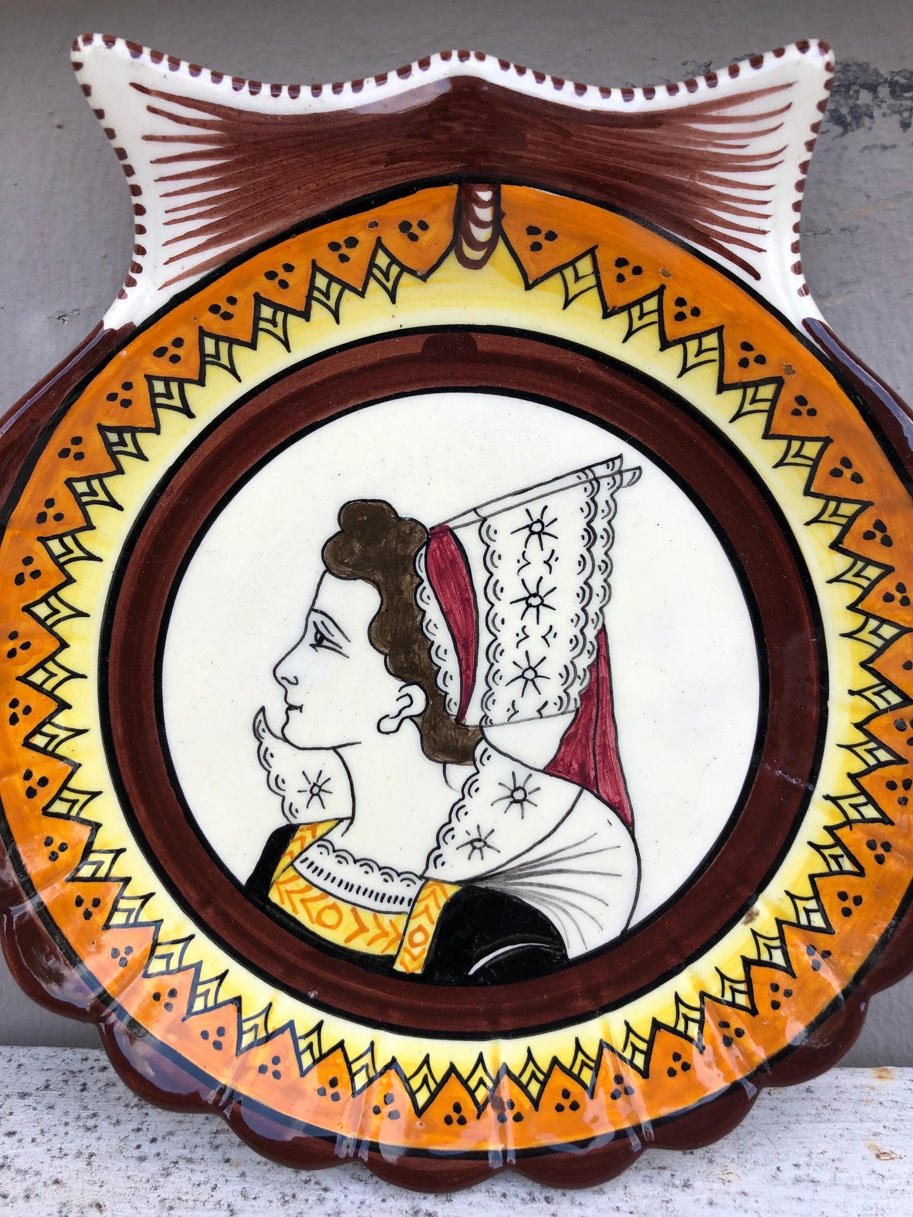 French Faience shell plate Henriot Quimper circa 1930.
Painted with a bretonne with her traditional costume.