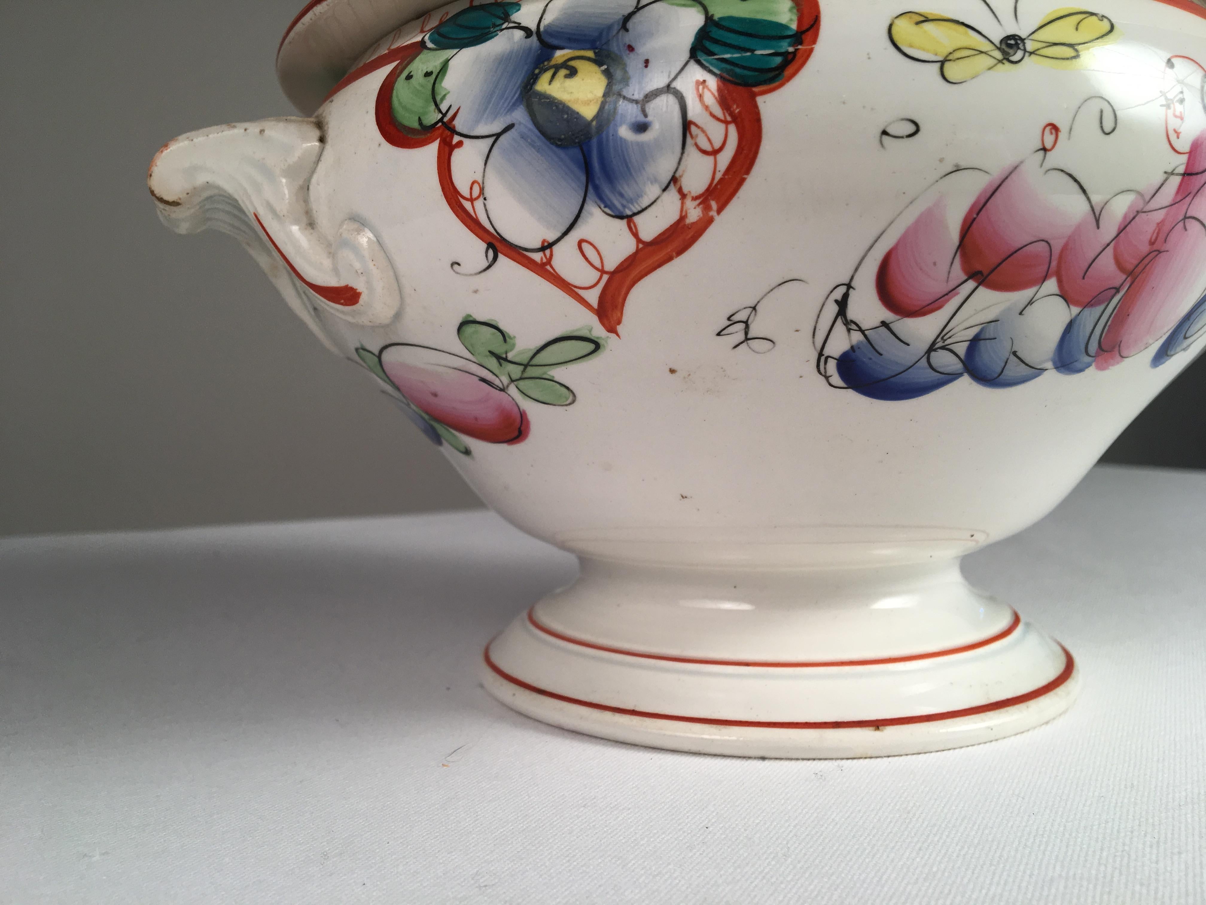 A French faience soup tureen with chinoiserie decoration, mid-late 19th century. Original lid.