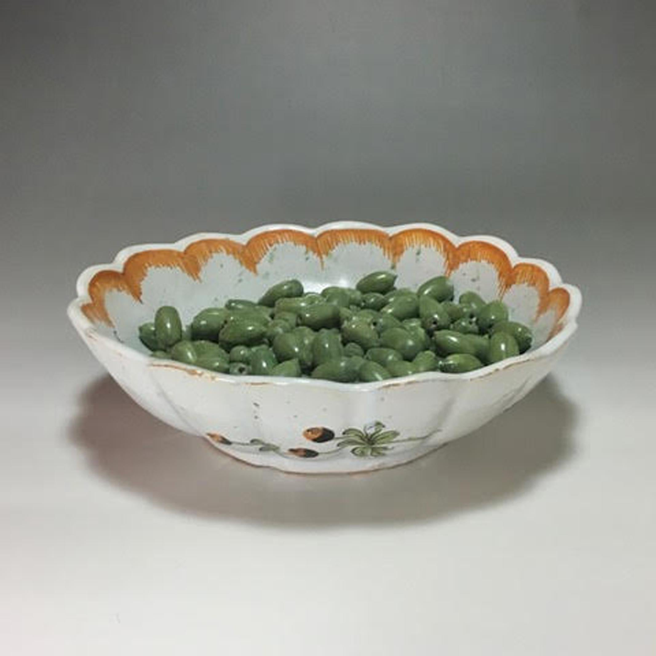 French Faience Tromp L'oeil bowl with olives, 
Nevers, Dated 1774
  

French Faience Trompe L'oeil Bowl with Olives, 
Nevers, France,
Dated 1774

French Faience Trompe L'oeil deep dish or bowl filled with olives.

On the border an