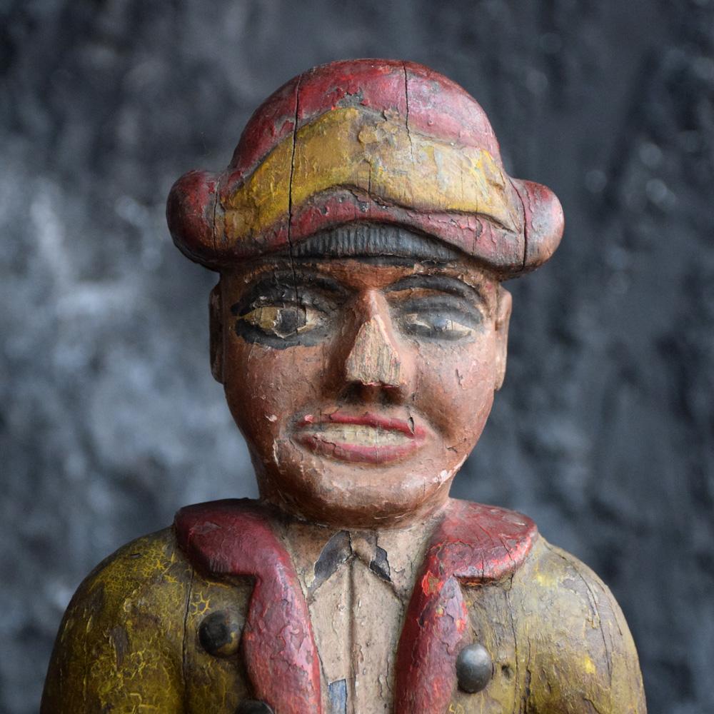 A wonderful example of a late 19th century French fairground Folk Art hand carved Jeu De Massacre figure. With amazing surface paint, sectioned wood carved detail and original cast metal swinging rod. A unique and highly collectable fairground