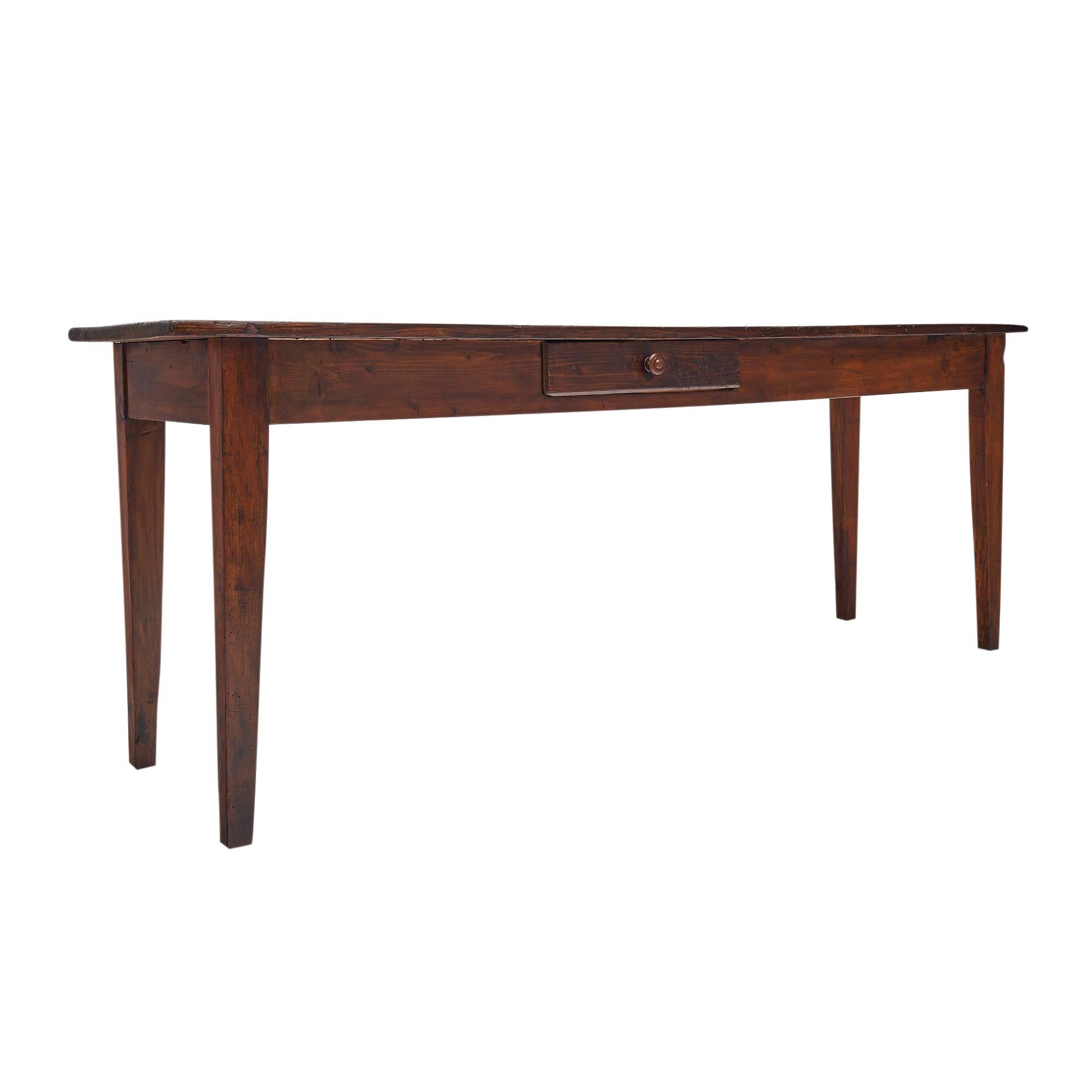 Farm console table from France made of solid wood construction, with a hand rubbed wax finish. The table has the classic provincial simple lines of French farm furniture. There is a dovetailed drawer on one side with a hand-turned wood knob. It is