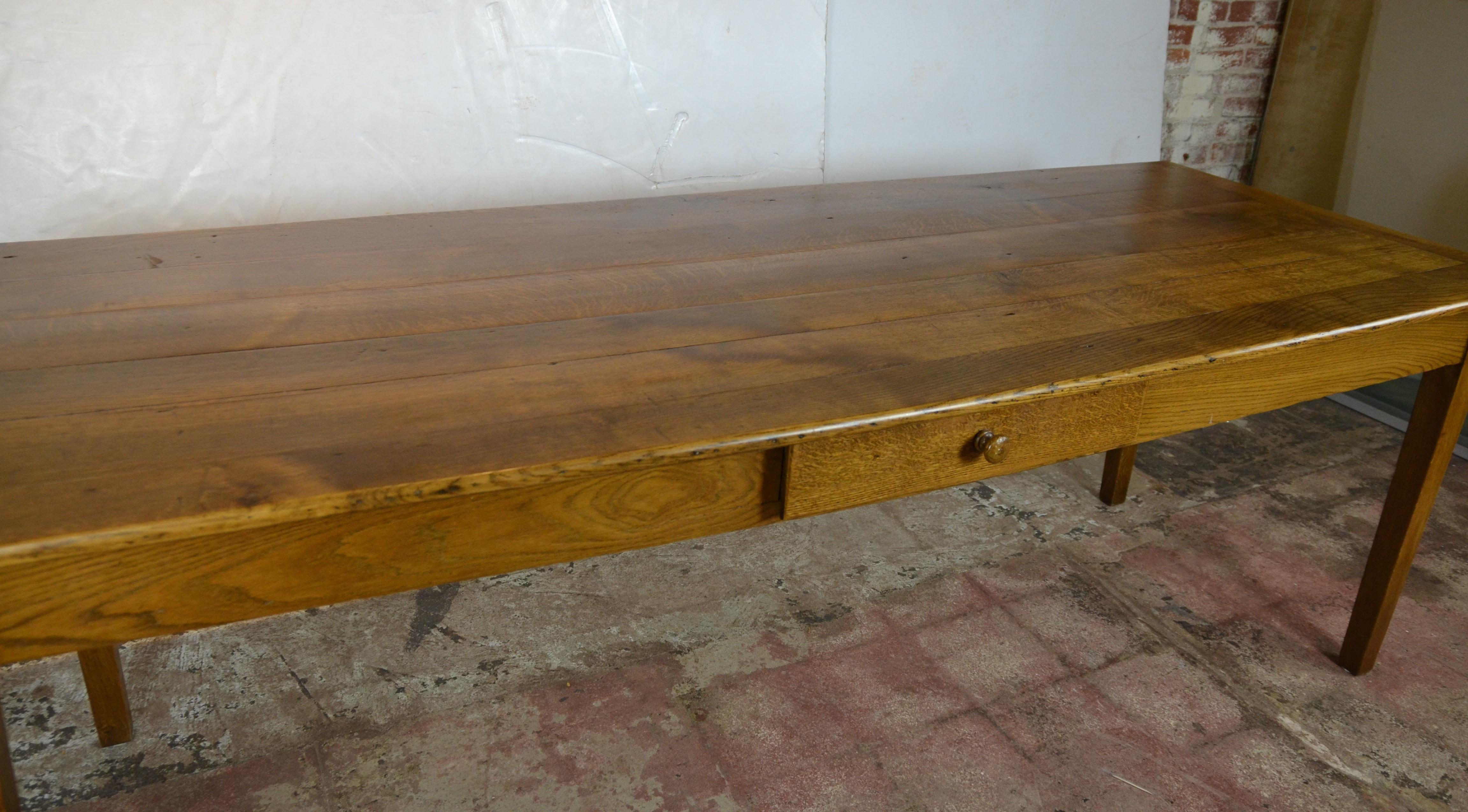 19th century restored oak French farm table with a single drawer the color and the wood grain is beautiful not too light not too dark. Apron height is a comfortable 25.50