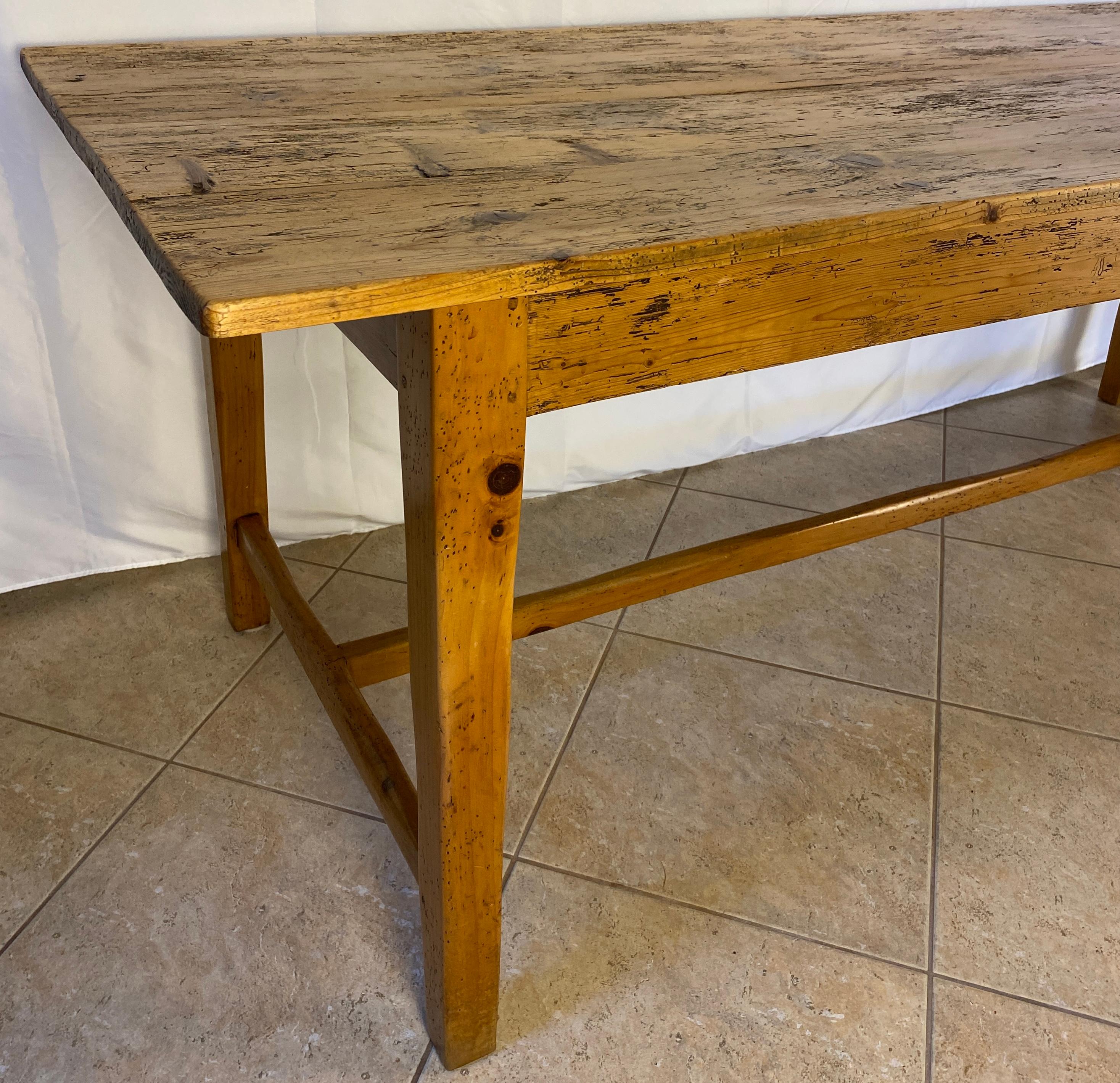 A charming large French Provincial farm table with H stretcher.  

This beautiful 20th century French farmhouse table of generous proportions boasts excellent golden colour. Its planks and purely solid pine construction makes this a great find. The