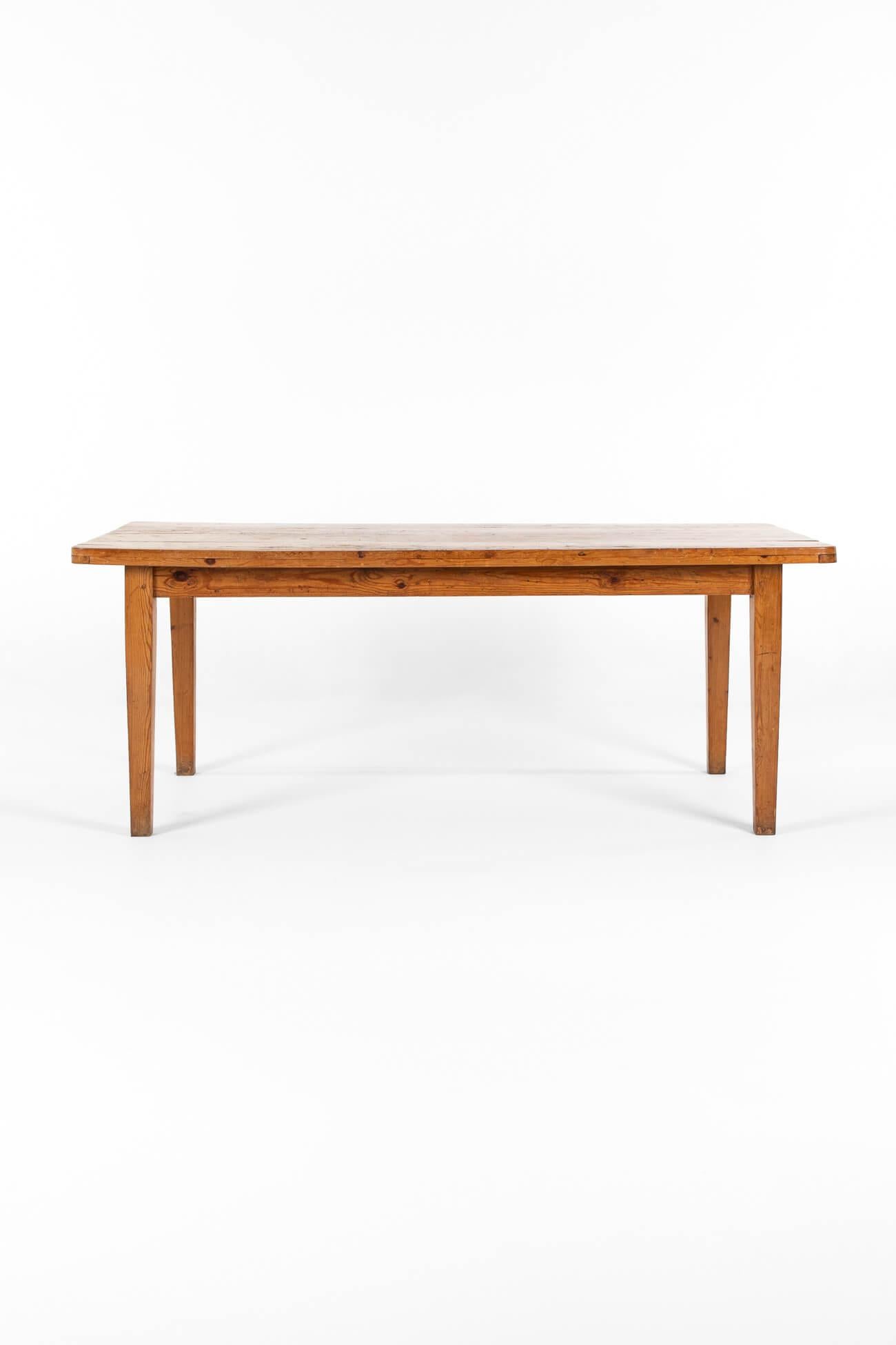 A French farmhouse table in pine with wonderful character and patina.

It features a thick oversized top with rounded corners over a peripheral apron, raised on four tapered legs.

One of the best tables we have had in the collection.

France, circa