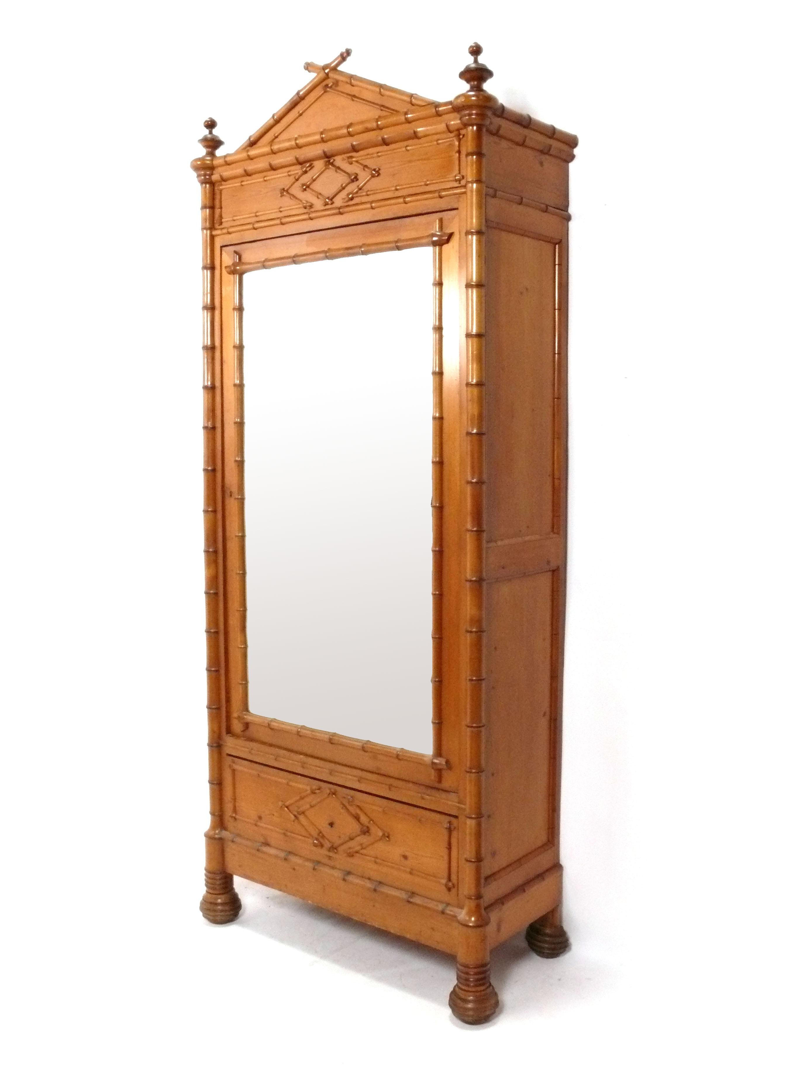 Antique French Faux Bamboo Armoire or Cabinet, France circa later 19th Century. It has a voluminous amount of storage with the door opening to reveal several shelves. It is a versatile size and can be used in a living area as an armoire, media