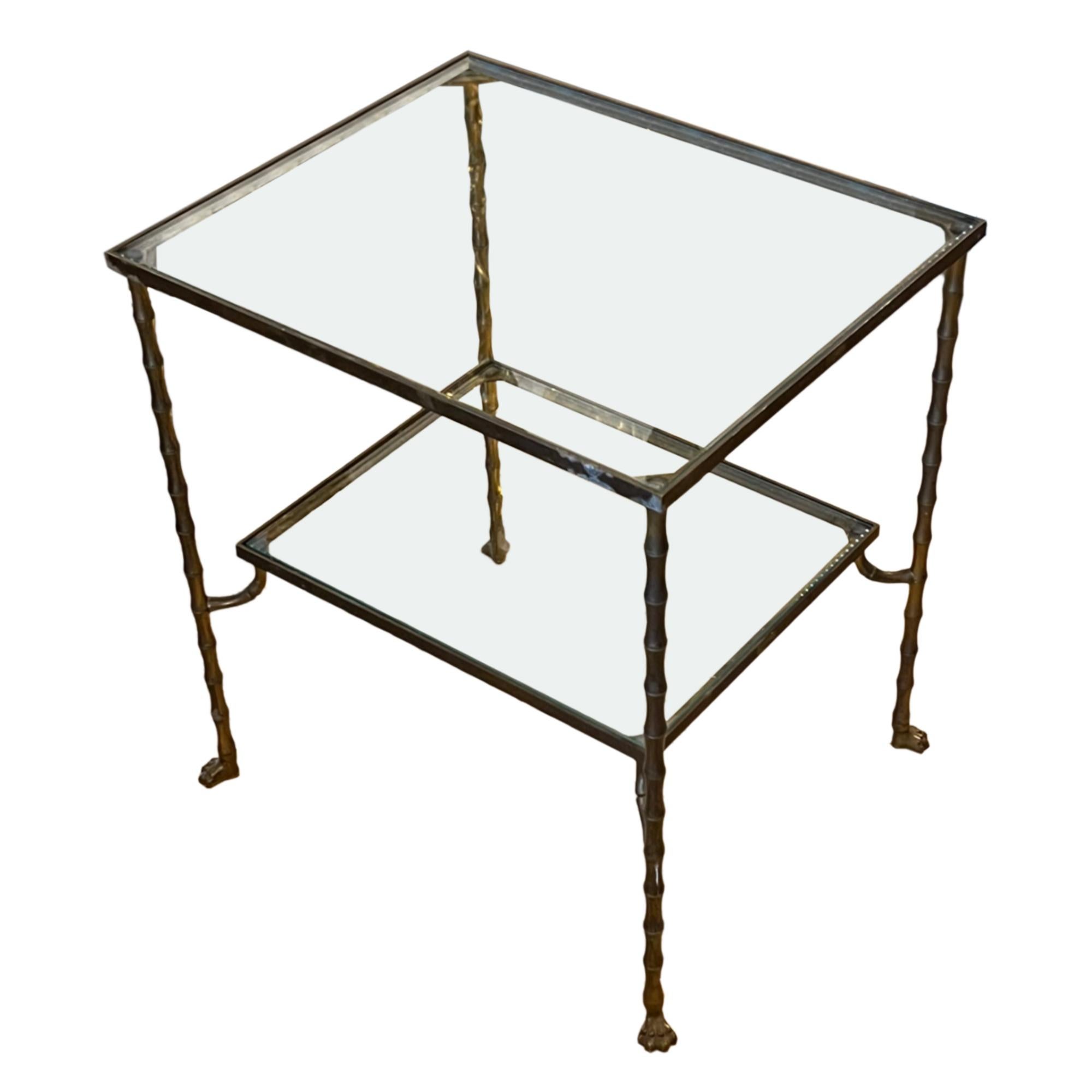 This is a lovely French 1960s side table, made from brass with a faux bamboo design with delightful paw feet.

A good size - the lower shelf, with elegant supporting arms is slightly smaller than the top. Perfect for the living room, study or