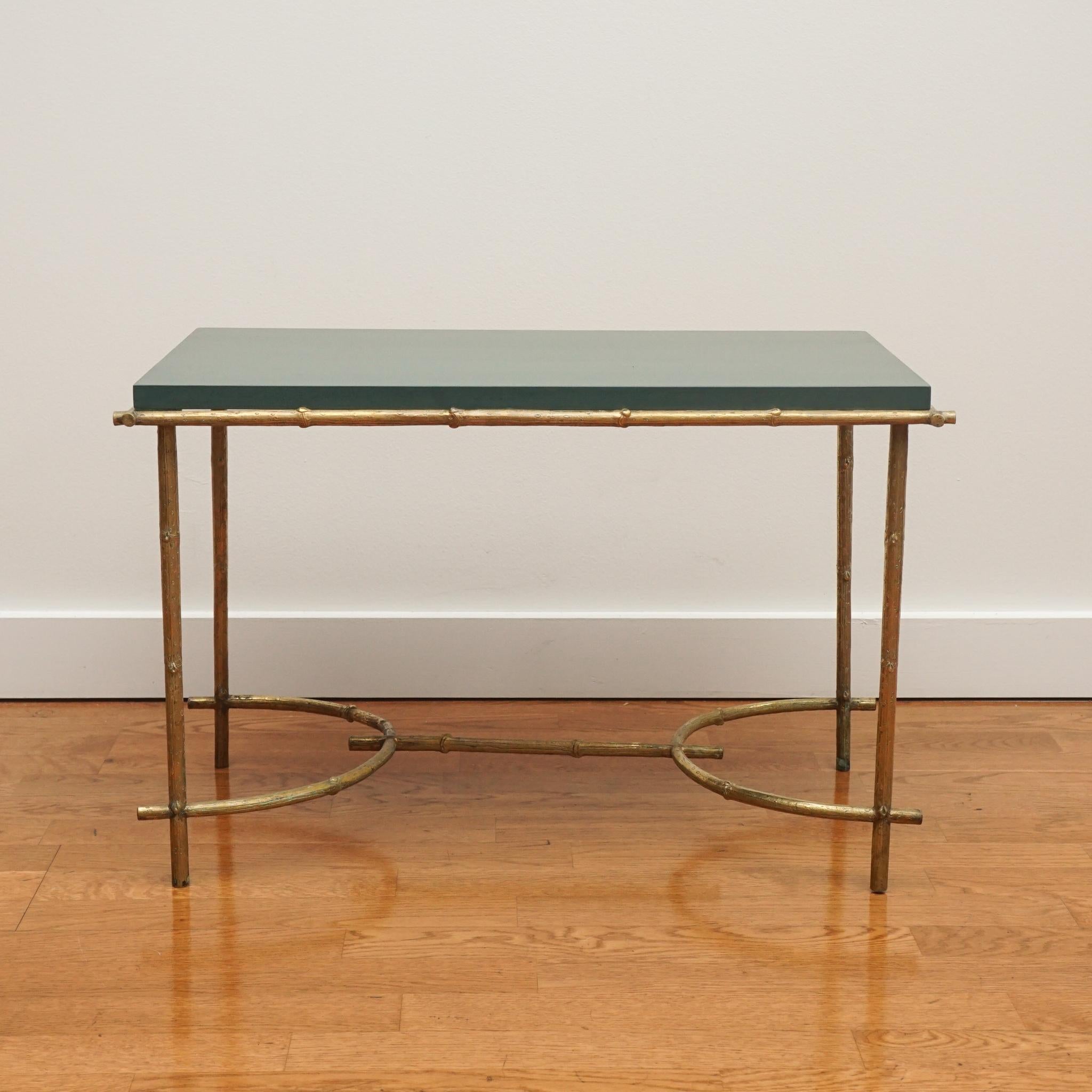 Made in the 1940s, this French neoclassical-style faux bamboo coffee table is a real jewel with its brass finished legs and stretcher and newly lacquered green table top.  If you are looking to add style and color to your home, this is the coffee
