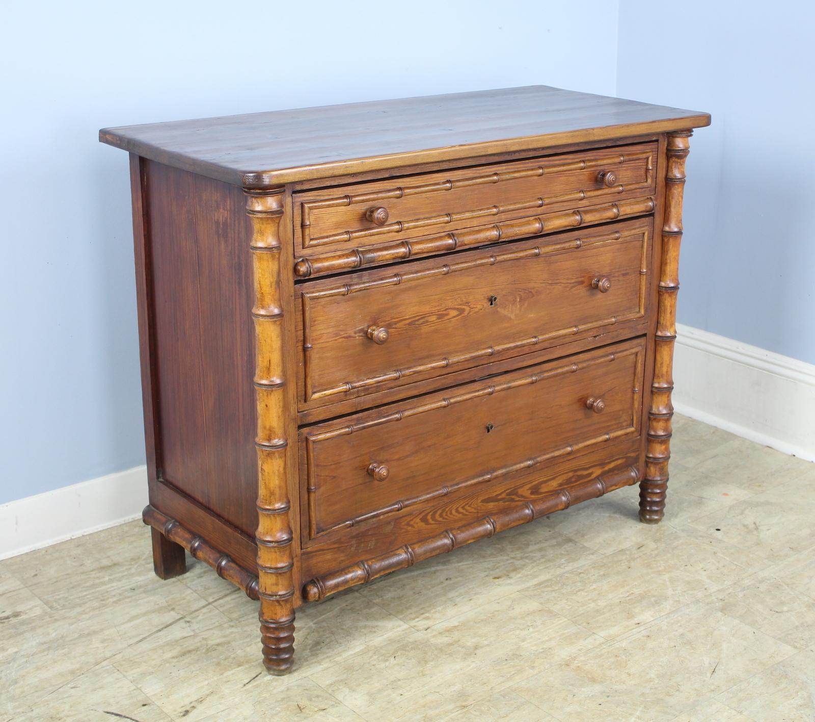 A charming chest of drawers with faux bamboo columns and mouldings. Three roomy drawers with lots of applied faux bamboo detail in good condition.