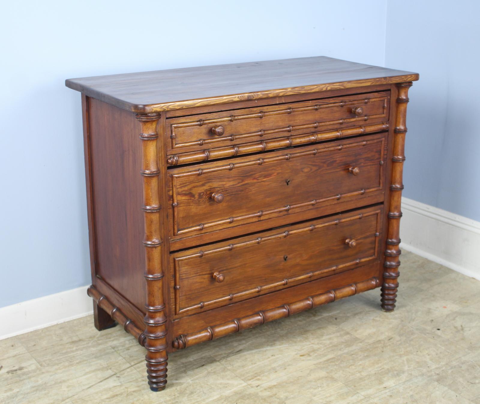 A charming chest of drawers with faux bamboo columns and mouldings. Three roomy drawers with lots of applied faux bamboo detail in good condition.