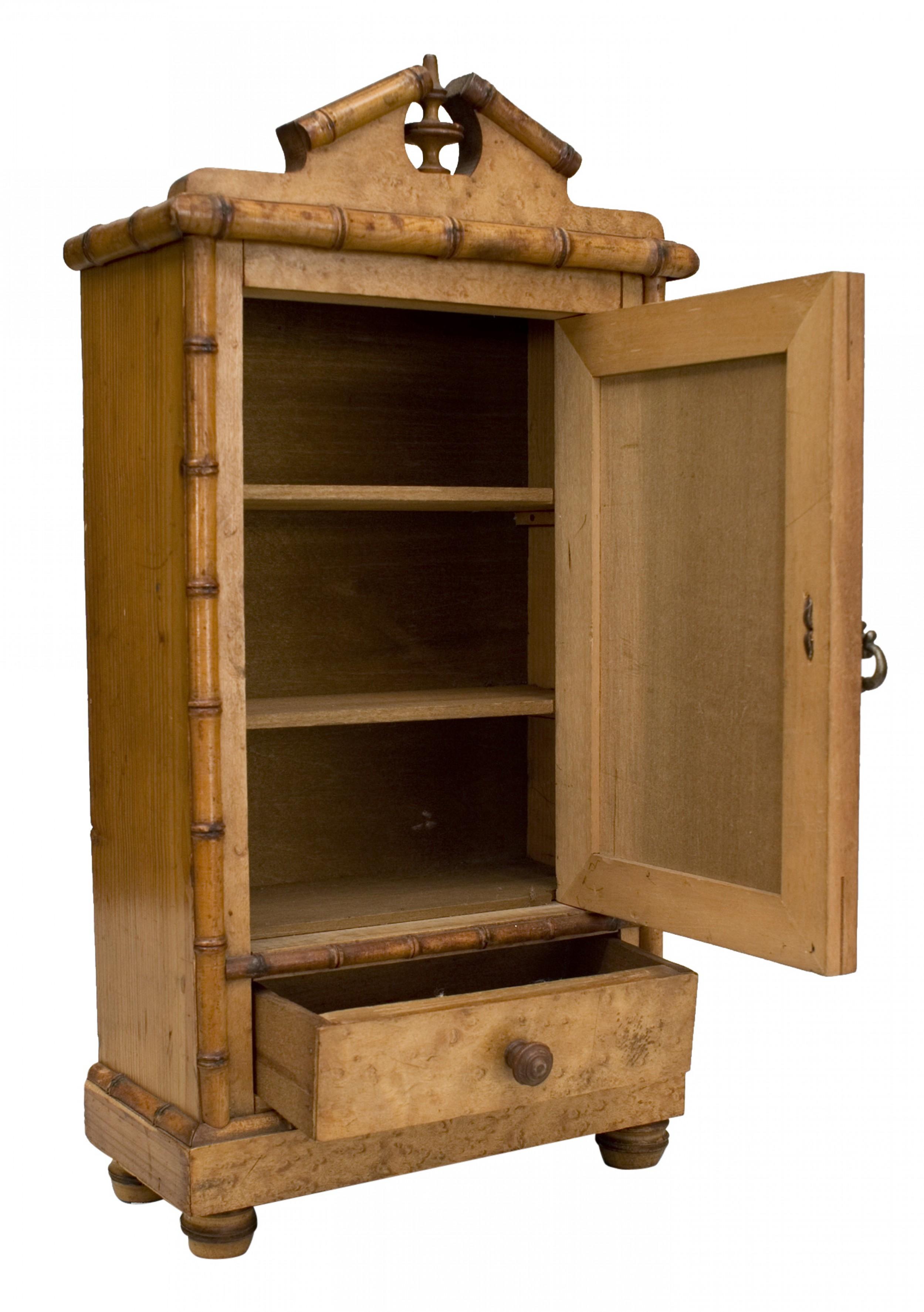 French Faux bamboo maple miniature armoire with a large mirrored door above a drawer with a pediment top