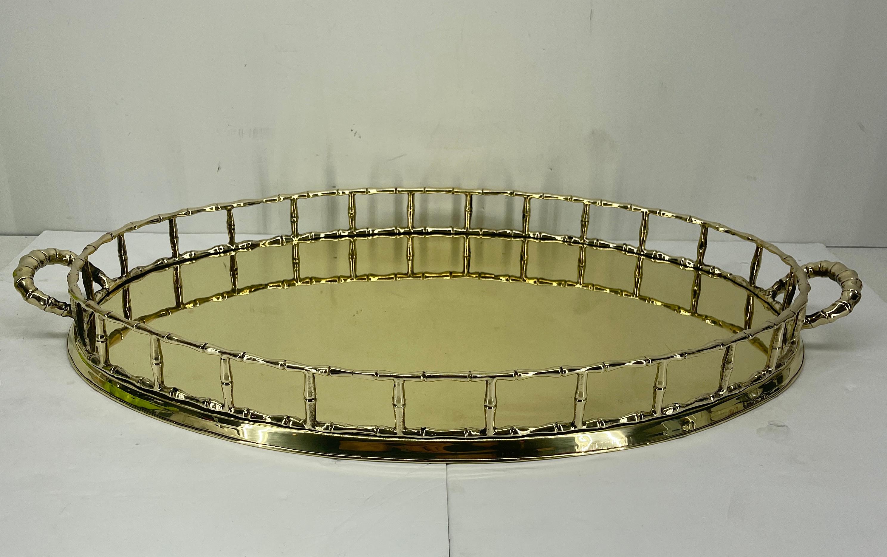 Vintage Hollywood Regency French serving tray. This beautiful polished brass faux bamboo oval tray is an excellent addition to your bar. The cocktail tray is elegant and timeless in style. The vintage large oval faux bamboo tray is regal and a