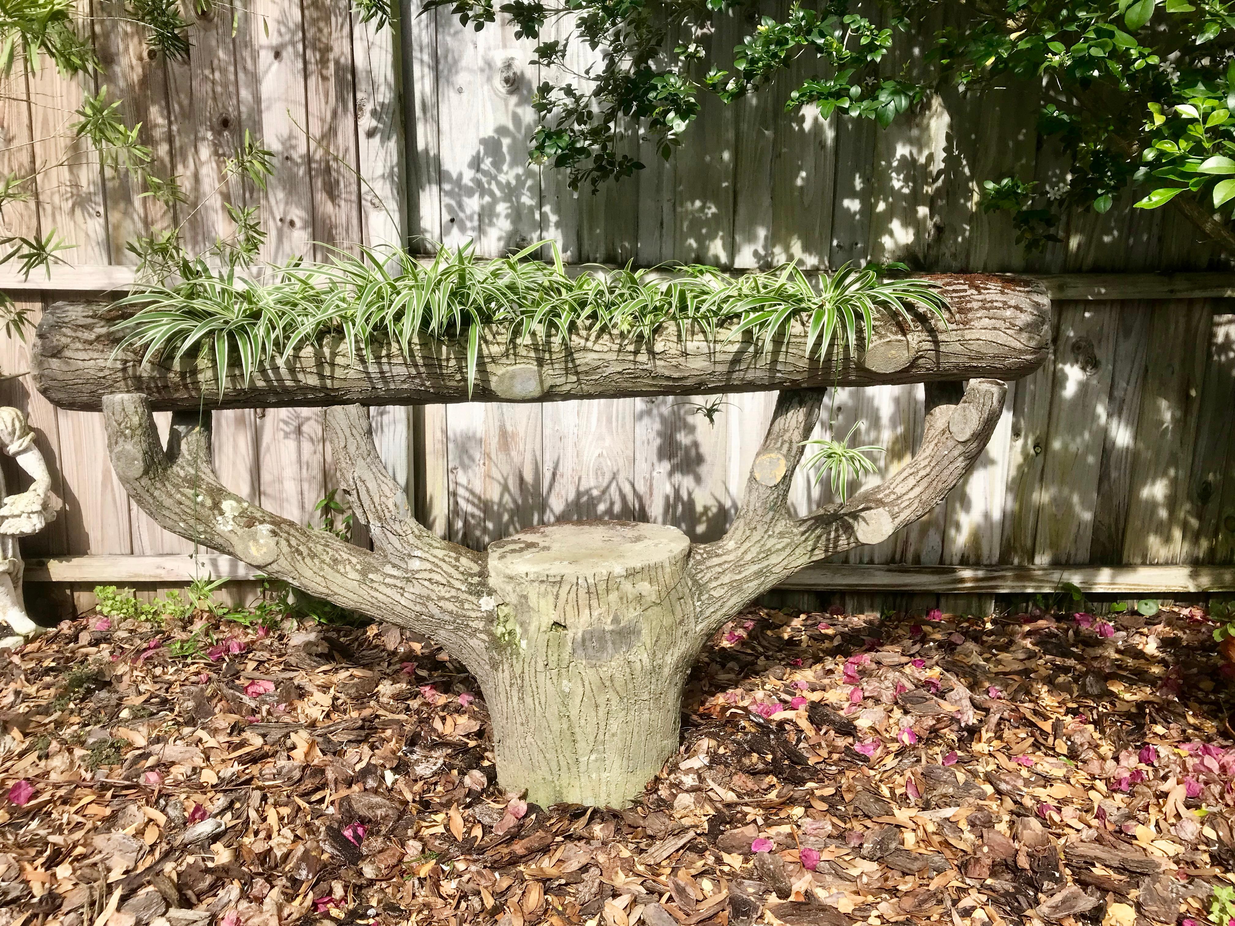 An unusual French faux bois concrete planter. Very realistic sculpted tree stump with cut limbs and textured bark. A hollowed out concrete log rests across the top and has drainage holes for plants. Fantastic old mossy patina. Very heavy and well